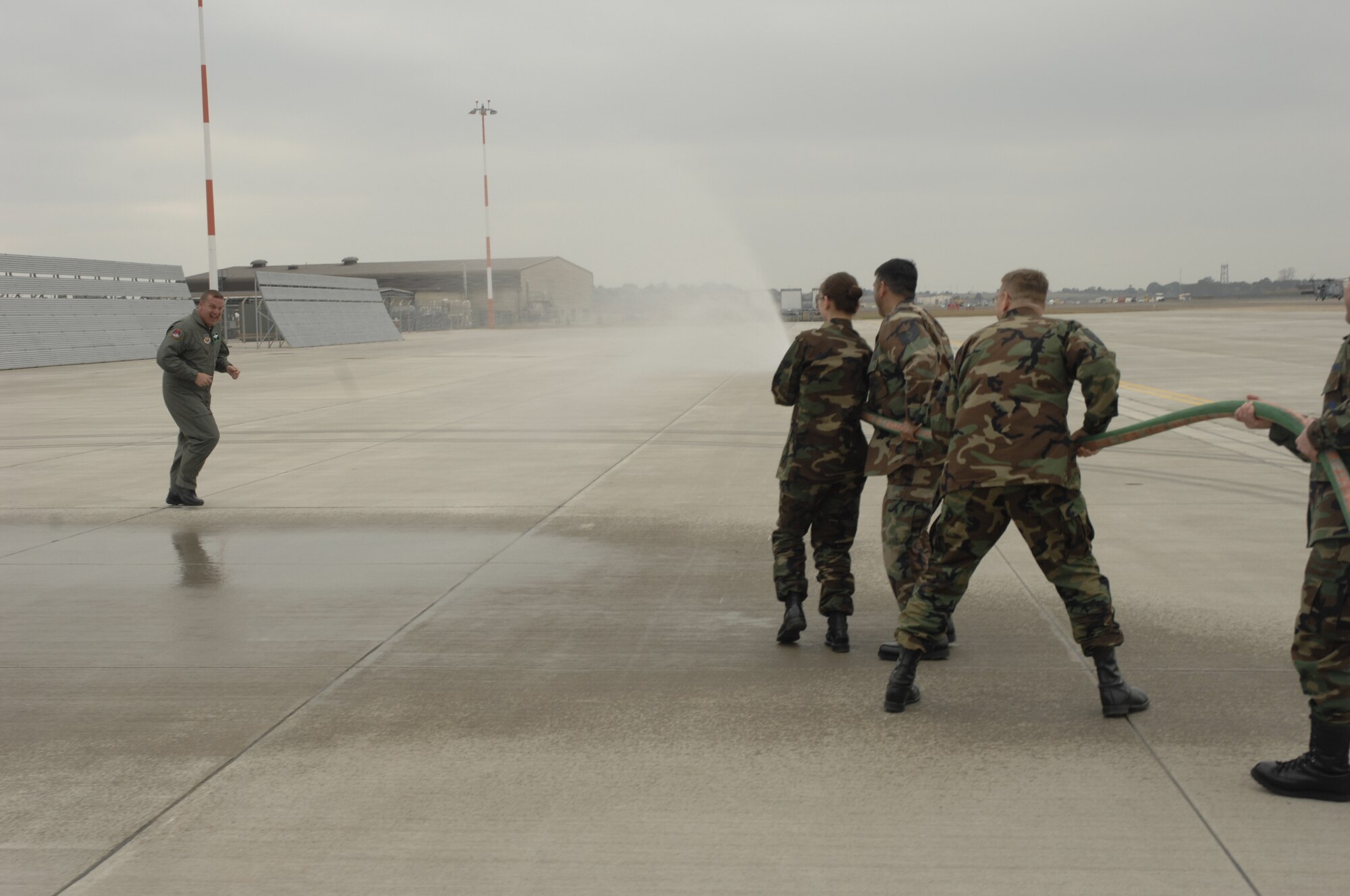 Members of the Liberty 56 scramble to hose down Command Chief Master Sgt. Jerry K. Sutton after his fini flight May 3. Chief Sutton retires May 18 after 22 years of Air Force service and a year and a half as the top enlisted Liberty Airman. During his tenure at RAF Lakenheath, Chief Sutton provided senior enlisted leadership for four groups and 22 squadrons consisting of over 5,000 enlisted personnel.  