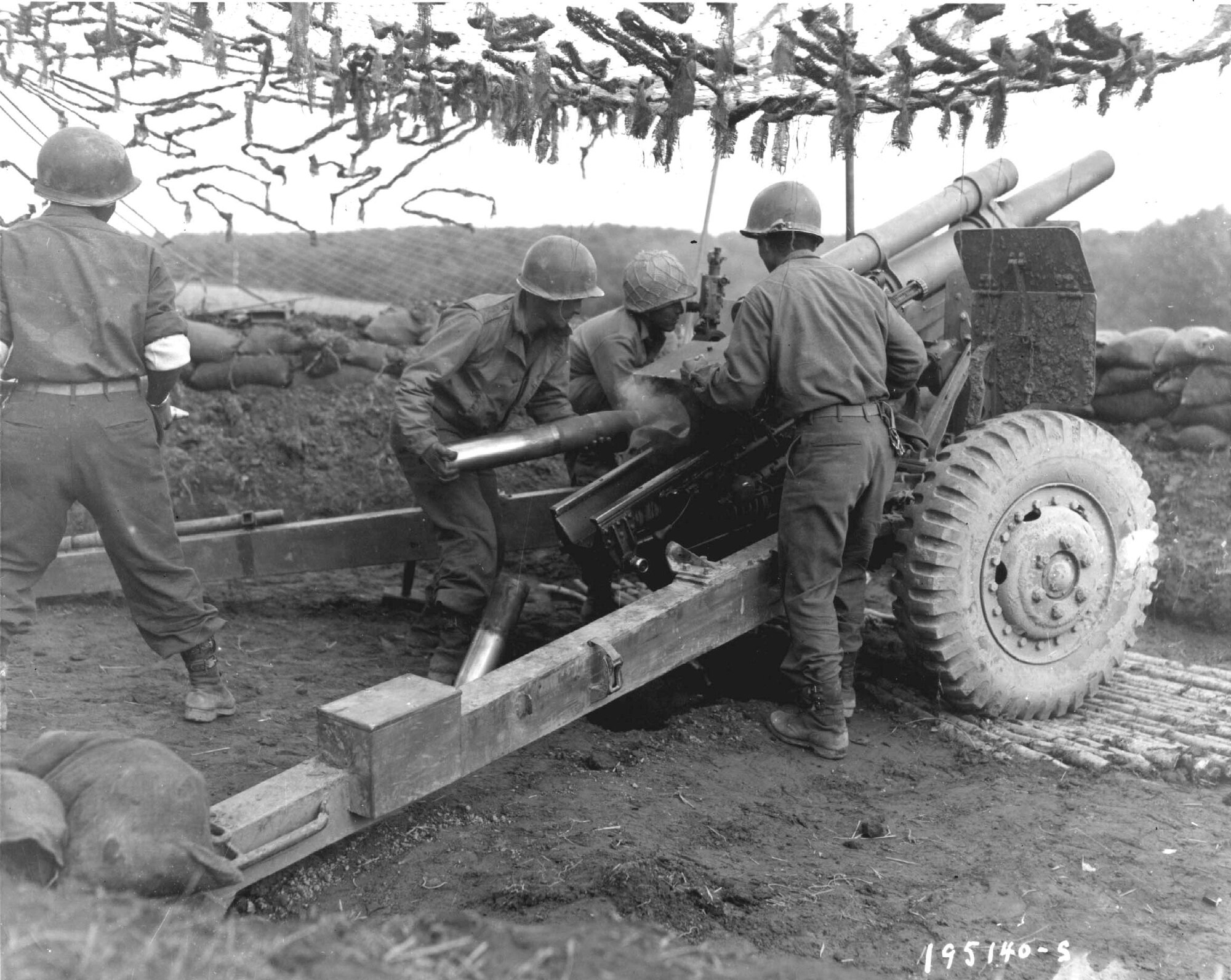 France 1944 - A team of Japanese-American G.I.'s fire 105mm shells at Germans in support of an infantry attack Oct. 18, 1944 in the Bruyeres Sector, France. (Courtesy Photo)