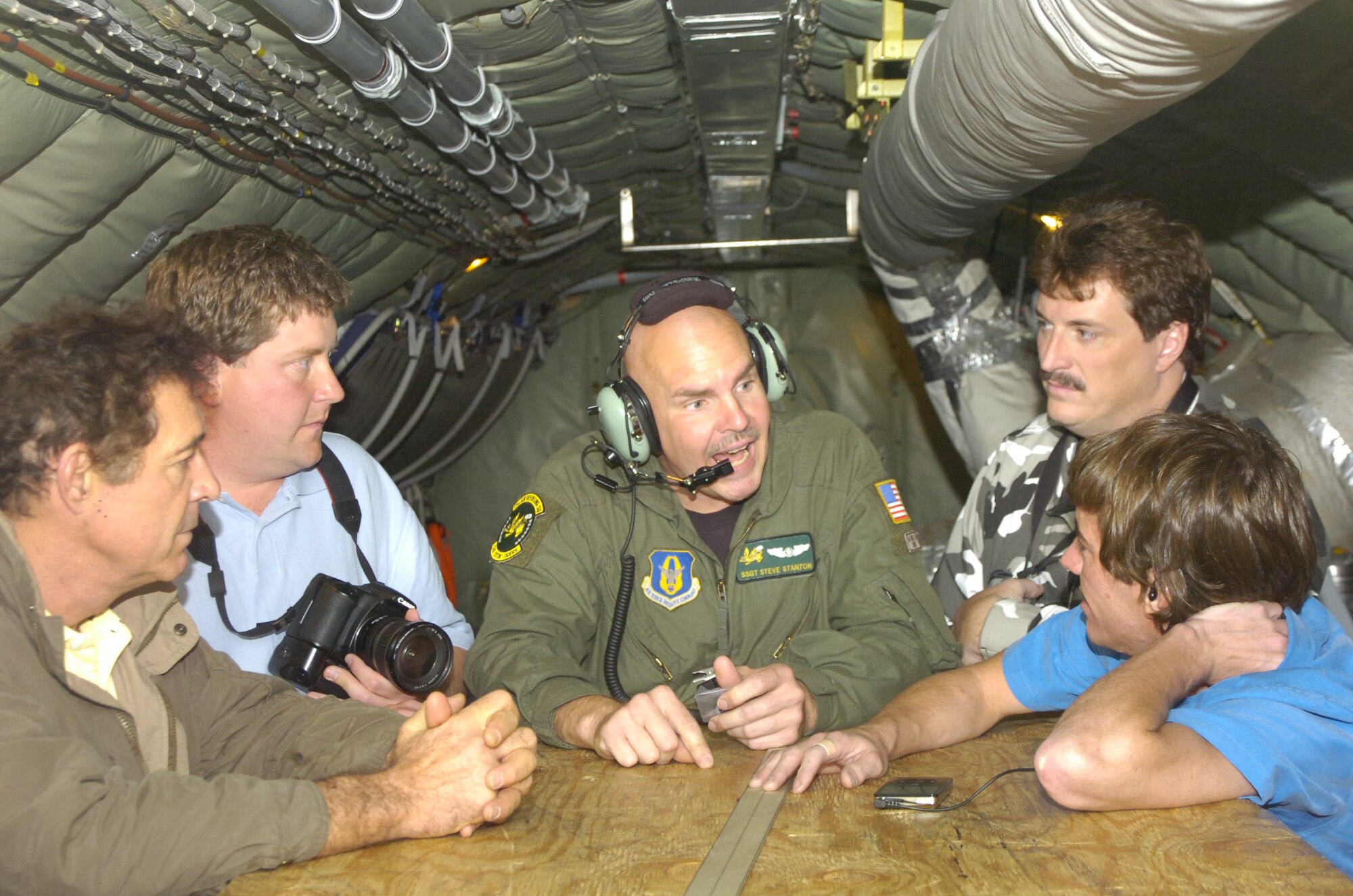 Seventies child star Barry Williams (front right) enjoyed hearing the stories of KC-135R boom operator Tech. Sgt. Steve Stanton, during a recent mid-air refueling flight to promote the Wing Over Wayne Air Show on May 12. Williams was joined in the air by World Air Show Magazine freelance reporter Jon Houghtaling, musician Eric Hoerner and NASCAR #21 driver Jon Wood. The 916th Air Refueling Wing, Air Force Reserve, hosted the group as part of their participation with the annual air show held at Seymour Johnson Air Force Base. (U.S. Air Force photo/SrA Ciara Wymbs) 