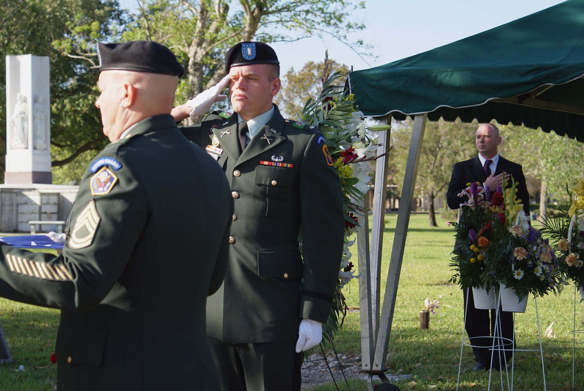 Ryan Ayers (right) pays his respects during a funeral as an Army honor guard detail prepares the American Flag for presentation to the family of a WWII veteran at a Miami funeral home March 31. While out of uniform, he preaches funerals and is often requested as a guest speaker at churches around South Florida. The Air Force Reserve Command recently recognized him as the 2006 Citizen Airman Outstanding Reserve Chaplain Assistant of the Year for his work as a chaplain assistant in the Air Force Reserve. (U.S. Air Force photo/Dan Galindo)