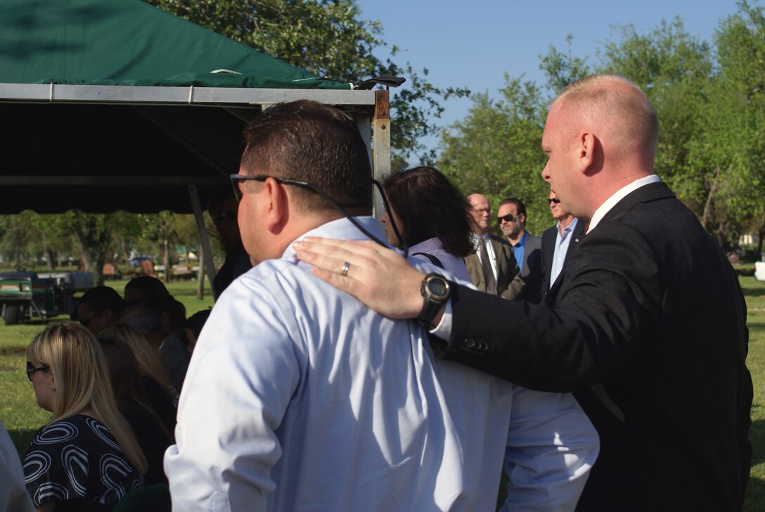 Ryan Ayers (right) consoles a family member during a funeral March 31 in Miami. While out of uniform, he preaches funerals and is often requested as a guest speaker at churches around South Florida. The Air Force Reserve Command recently recognized him as the 2006 Citizen Airman Outstanding Reserve Chaplain Assistant of the Year for his work as a chaplain assistant at Homestead Air Reserve Base, Fla. (U.S. Air Force photo/Dan Galindo)
