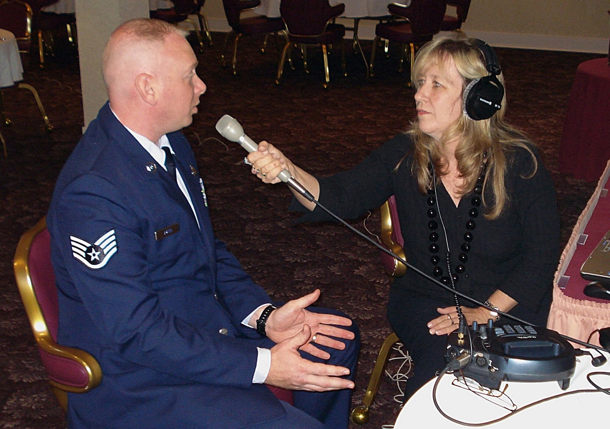 Staff Sgt. Ryan Ayers interviews with a local radio station personality, Donna Gean Matthews of WMCU Spirit FM, during the National Day of Prayer breakfast here May 3. Sergeant Ayers has been the lead planner and coordinator the last three years for the event. Air Force Reserve Command recently recognized him as the 2006 Citizen Airman Outstanding Reserve Chaplain Assistant of the Year. (U.S. Air Force photo/Dan Galindo)