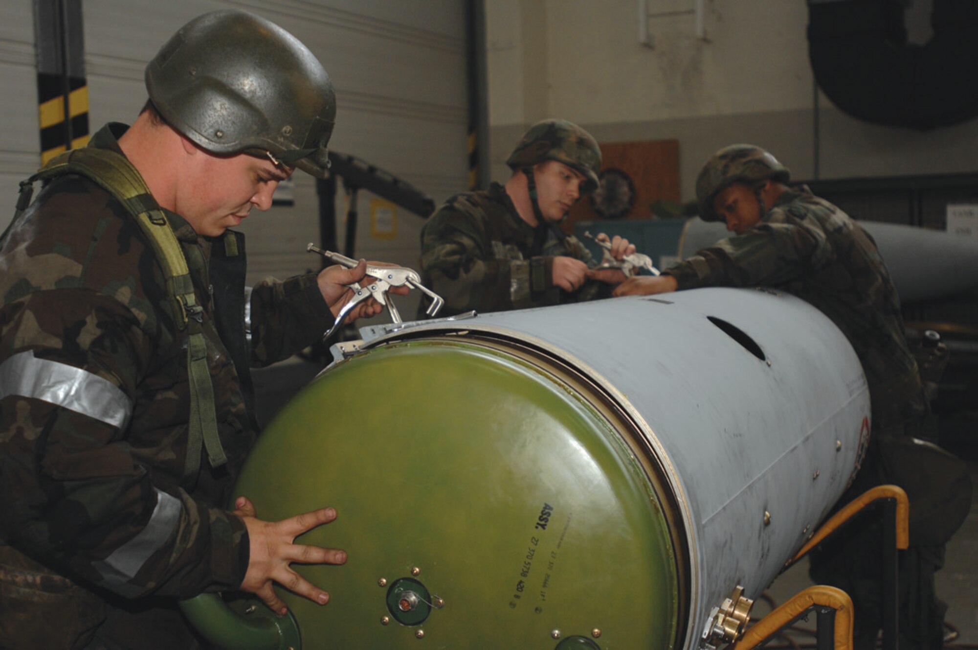 SPANGDAHLEM AIR BASE, GERMANY -- Senior Airman Jason Rachwitz, Staff Sgt. Cory Veronese and Airman 1st Class Bryan Faulk, from the 52nd Component Maintenance Squadron aircraft fuel systems repair shop, assembled a 370-gallon external fuel tank for an F-16 aircraft May 9. The Cobras conducted the tank build up, part of a War Reserve Material Team demonstration, to test their capability in preparation for June's Operations Evaulation. The demonstration is key to the squadron's success in the NATO inspection. (U.S. Air Force photo/Airman 1st Class Emily Moore)