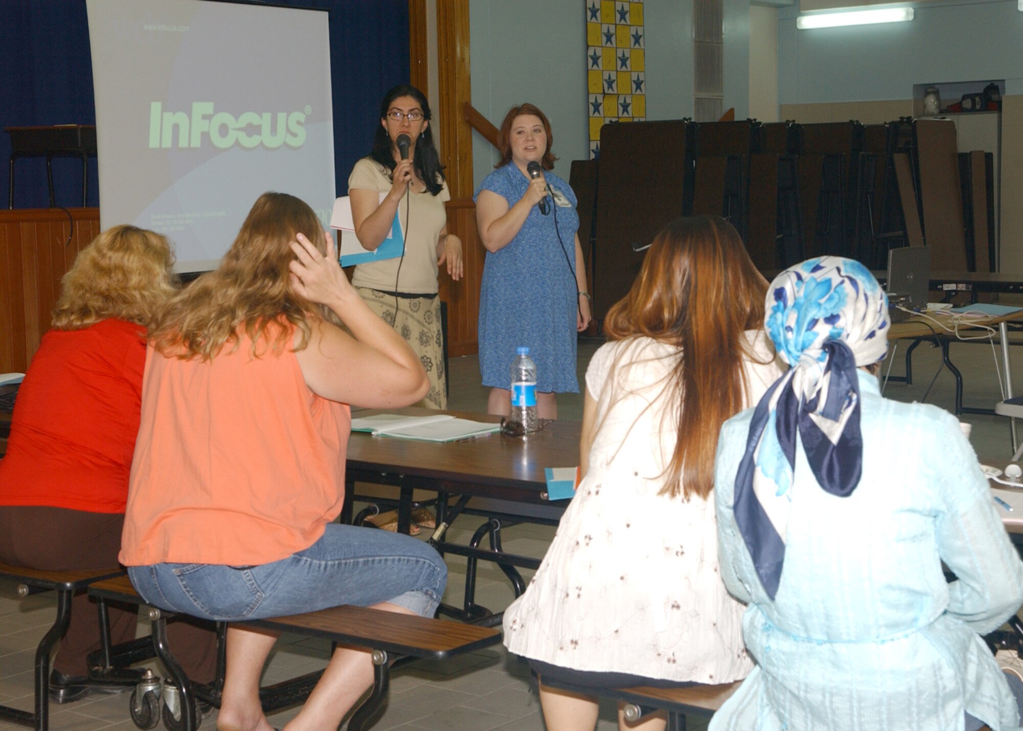 Ms Lesley Evans, right, a registered nurse, speaks at the Child Care and Development Seminar Saturday May 5 while Mrs. Ozlem Wierzbicki, left, translates.  The seminar was hosted by the Family Advocacy Program and included guest speakers who talked about cultural differences, behavior management, nutrition and food handling, dental care, early childhood education, and safety practices.  (U.S. Air Forces photo by Airman 1st Class Tiffany Colburn).
	

                               