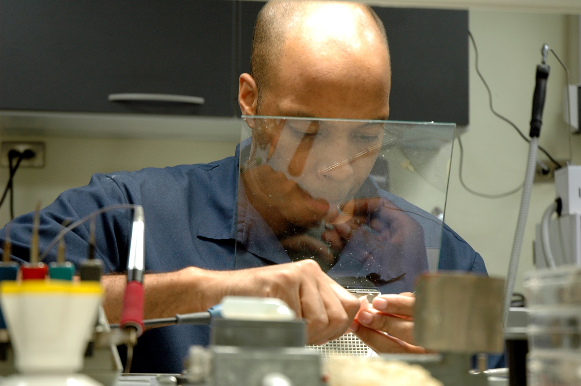 OSAN AIR BASE, Republic of Korea --  Staff Sgt. Kevin Franklin, 51st Dental Squadron lab technician, uses a face shielf while working on a set of removable partial dentures. Lab technicians must use different protective equipment depending on what they're doing. (U.S. Air Force photo by Staff Sgt. Benjamin Rojek)