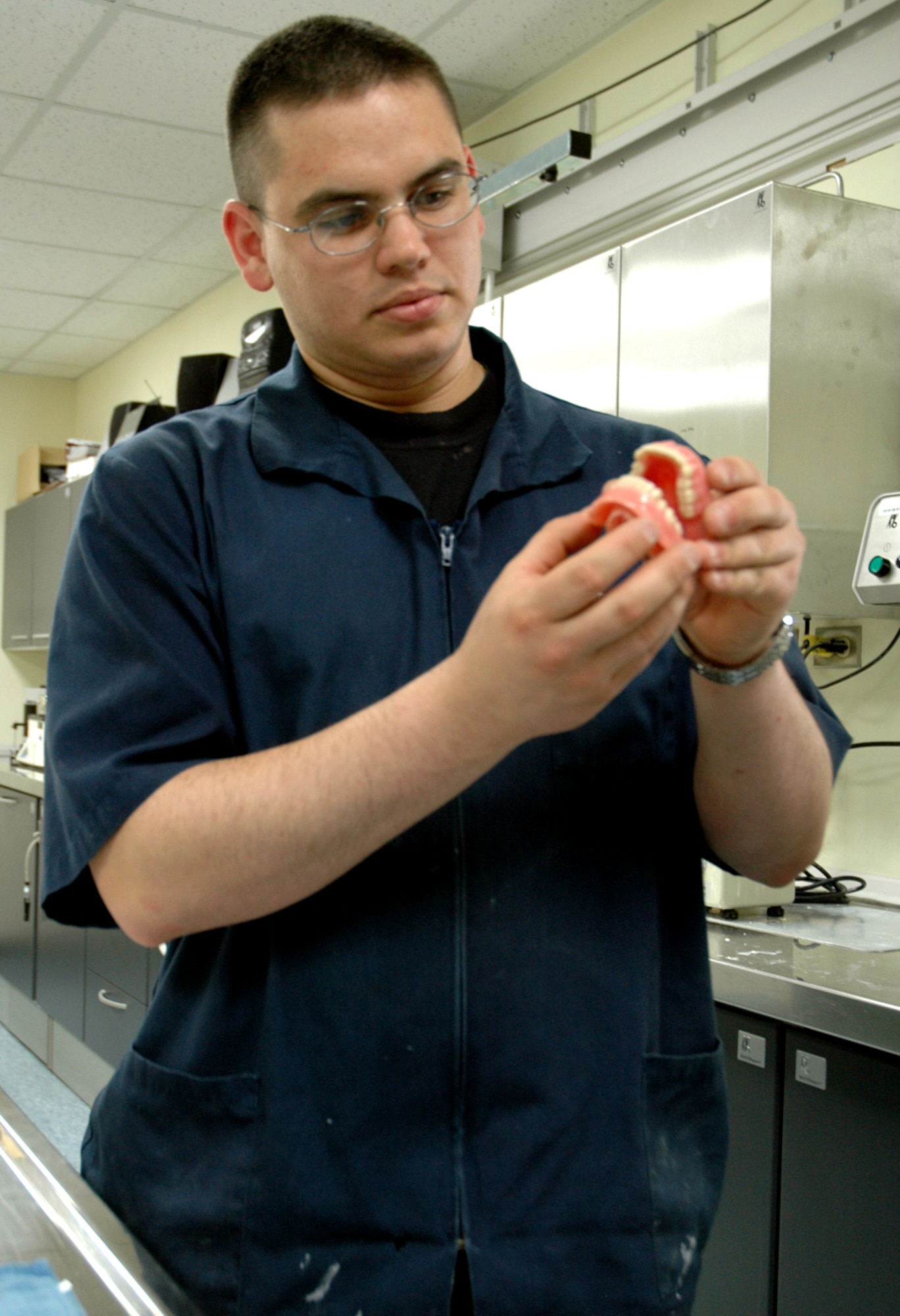 OSAN AIR BASE, Republic of Korea --  Senior Airman Ruben Hernandez, 51st Dental Squadron lab technician, checks finished dentures at the dental lab here Thursday. Dental lab technicians must complete six months of technical school, learning how to make everything from sports guards to bridges. (U.S. Air Force photo by Staff Sgt. Benjamin Rojek)