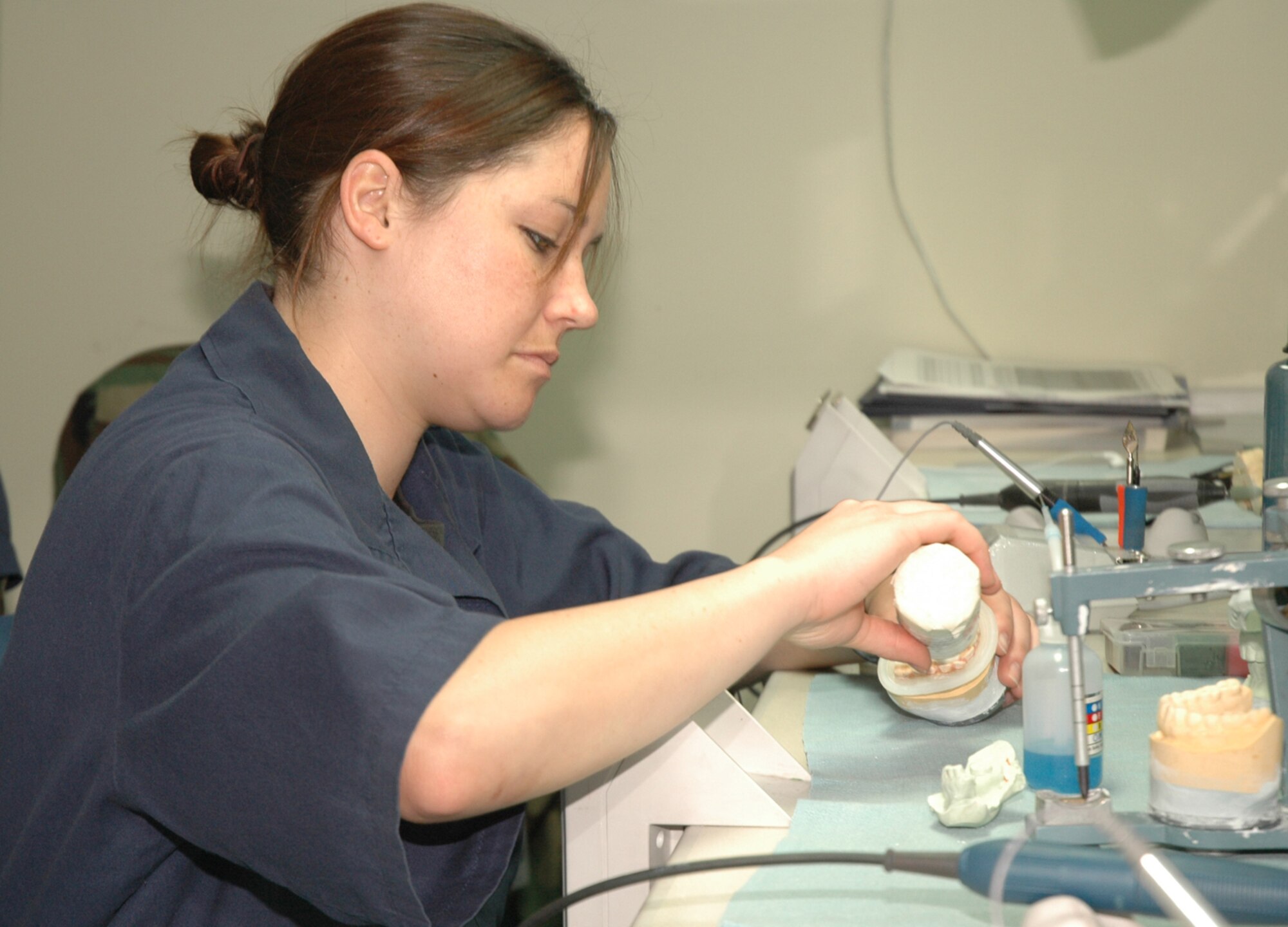 OSAN AIR BASE, Republic of Korea --  Senior Airman Jeni Bamford, 51st Dental Squadron lab technician, fabricates a nightguard in the dental lab here Thursday. Dental lab technicians make everything from crowns to dentures. (U.S. Air Force photo by Staff Sgt. Benjamin Rojek)