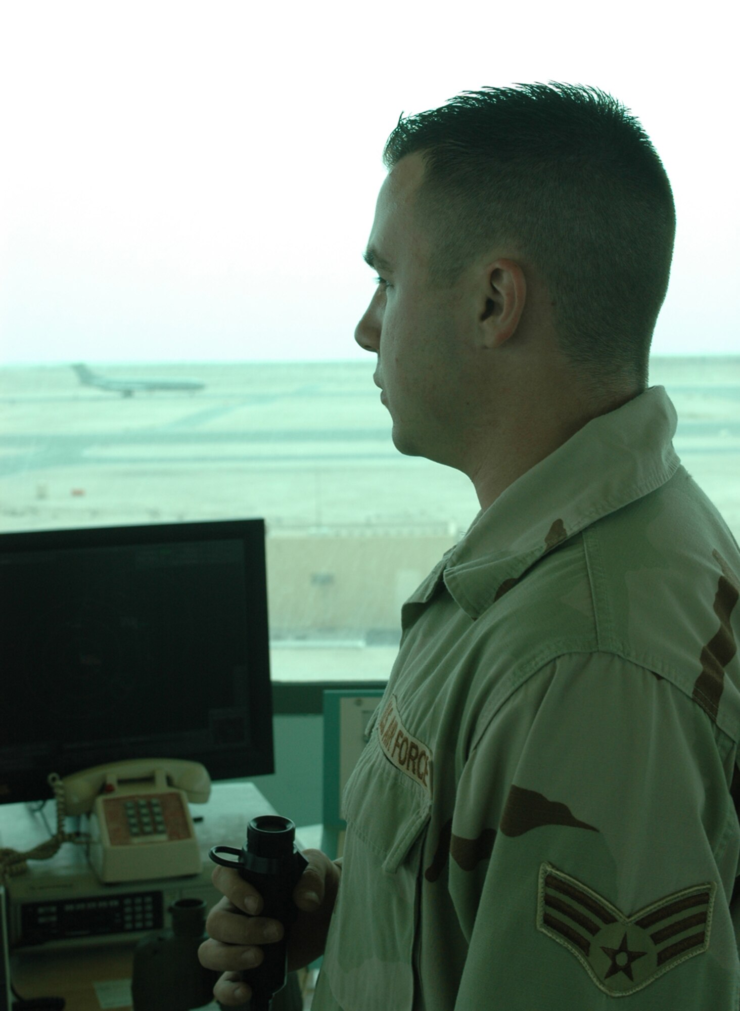 Senior Airman Dustin Storm, 379th Expeditionary Operations Support Squadron air traffic control journeyman, watches as a British Royal Air Force VC10 Air Tanker taxis after landing at the 379th Air Expeditionary Wing. (U.S. Air Force Photo/Senior Airman Erik Hofmeyer)