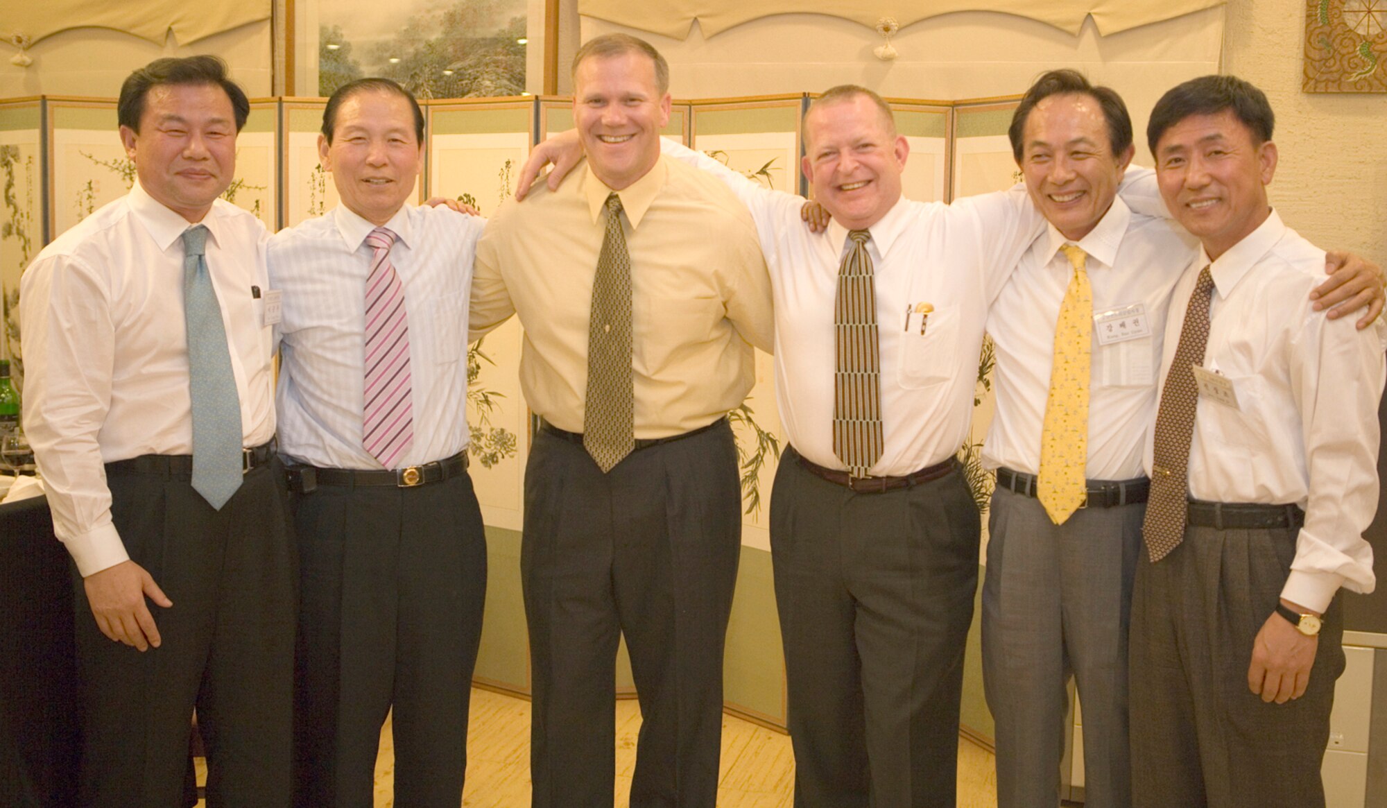 GUNSAN CITY, Republic of Korea  May 10, 2007 -- Col. Jeff "Wolf" Lofgren, 8th Fighter Wing commander (third from left) and Lt. Col. Dana Windhorst, 8th Medical Group deputy commander (third from right) join in their last group photo with Gunsan City mayor Moon, Dong Shin (second from left) and city council leaders during a farewell dinner May 10. Colonel Lofgren was also named an honorary citizen of Gunsan City for his "contribution to the development of Gunsan," according to the awards plaque. The 8th FW commander was joined by the unit's group commanders, where they were each recognized for their service to the community. (Courtesy photo)