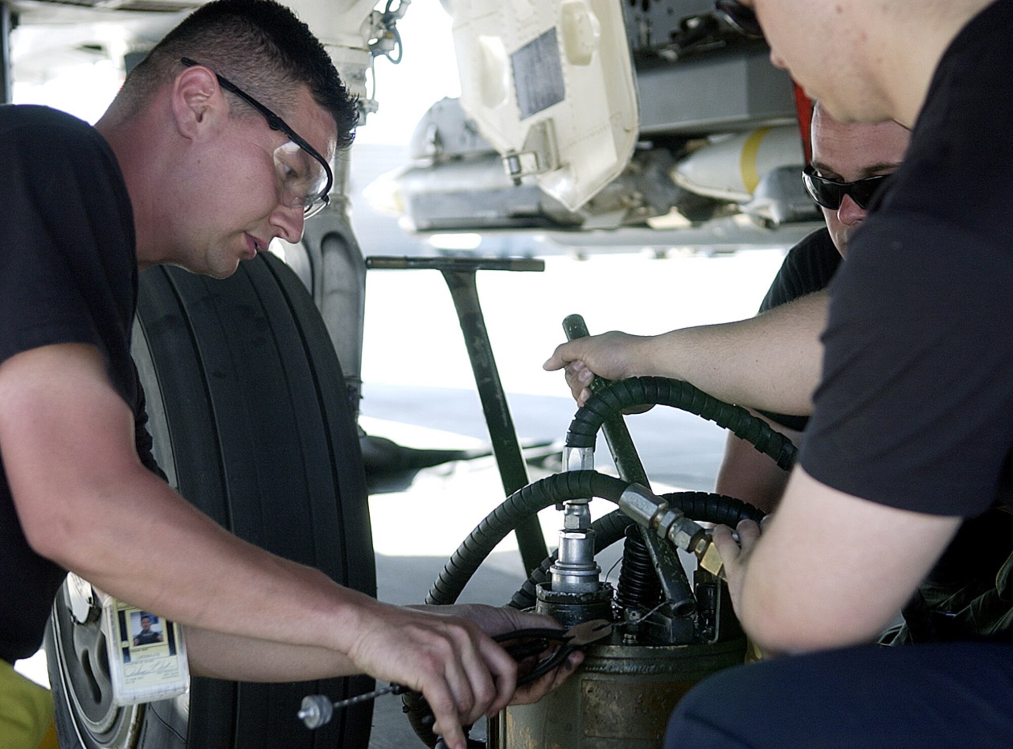 Crew chiefs with the 492nd Expeditionary Aircraft Maintenance Unit, prepare to service the hydraulic system of an F-15E Strike Eagle at Bagram Air Field, Afghanistan. They are deployed from Lakenheath Air Base, England. (photo by Staff Sgt. Craig Seals)