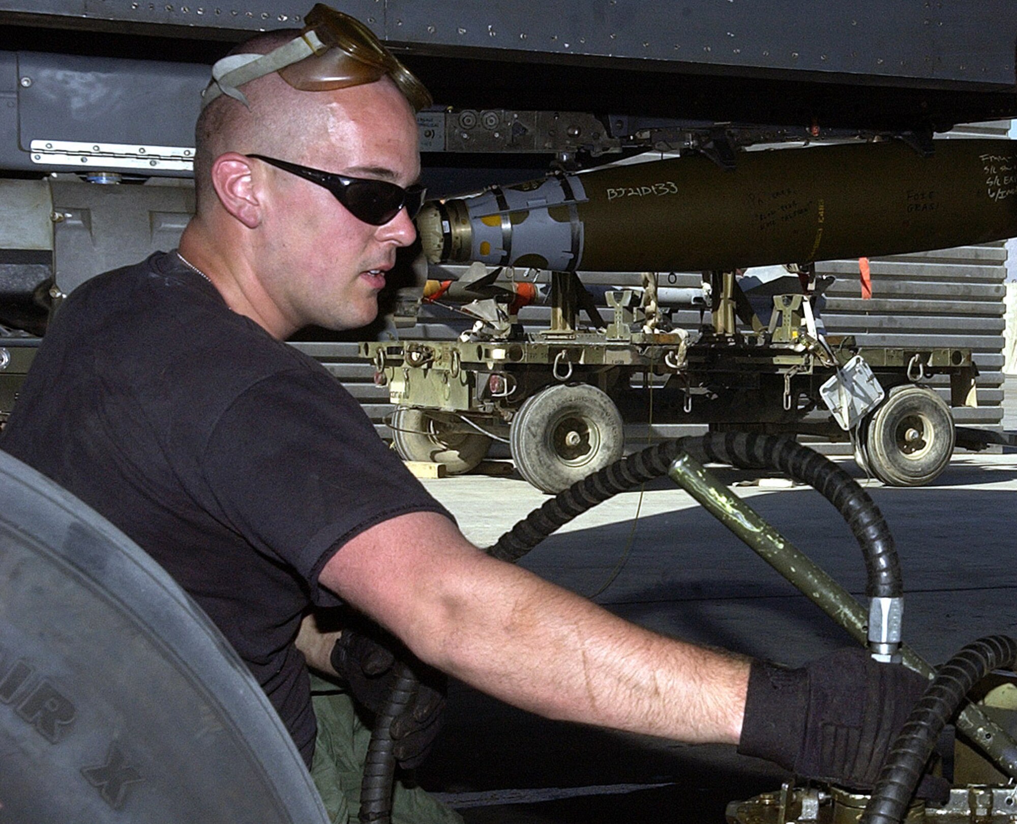 A crew chief with the 492nd Expeditionary Aircraft Maintenance Unit, prepares to service the hydraulic system of an F-15E Strike Eagle at Bagram Air Field, Afghanistan. He is deployed from Lakenheath Air Base, England. (photo by Staff Sgt. Craig Seals)
