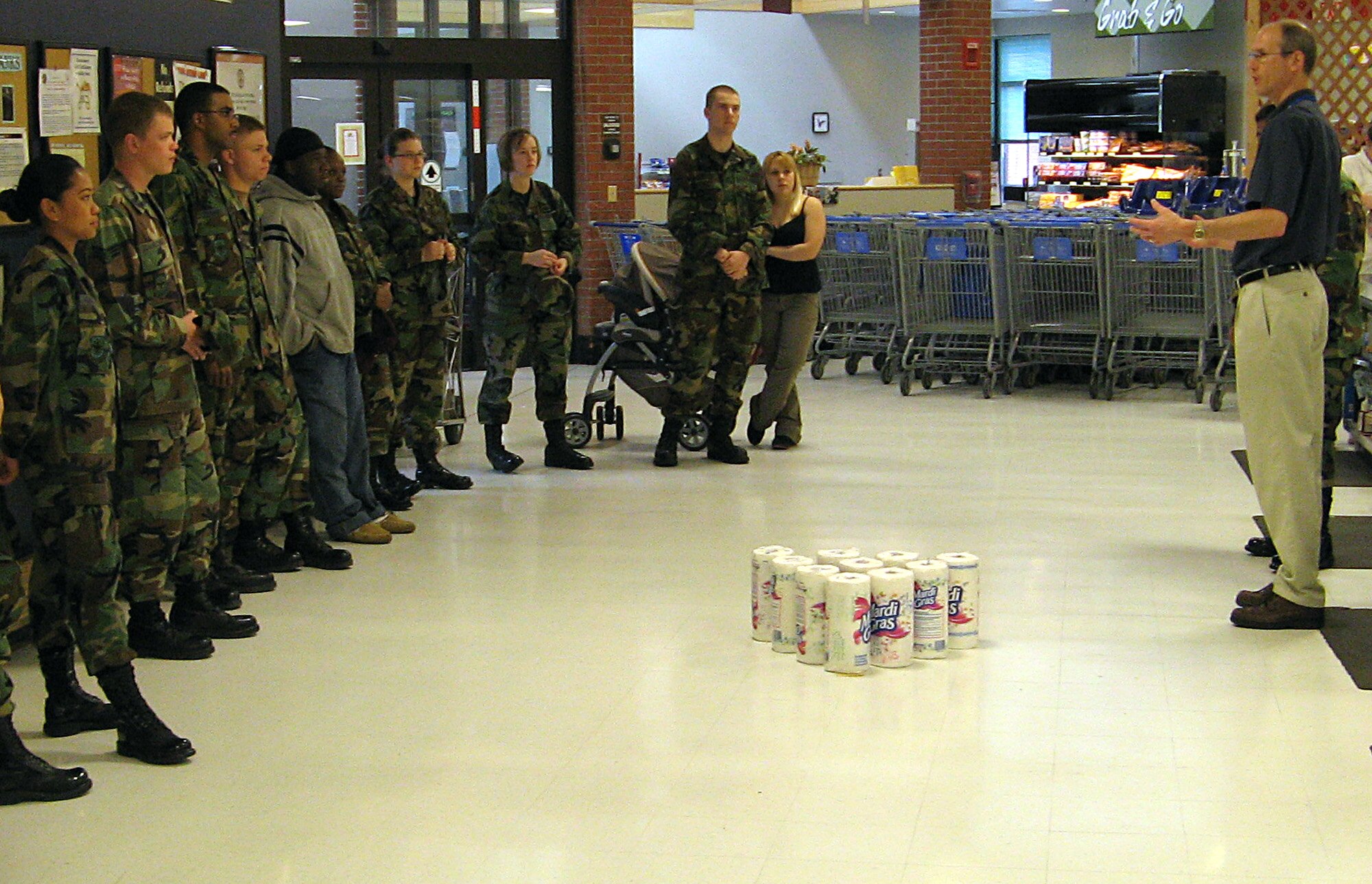 FAIRCHILD AIR FORCE BASE, Wash. -- Eric Quantock, store director, welcomes a group of first term Airmen to the commissary for the commissary awareness month event held May 10. Split into teams, the Airmen competed against each other in three events for the grand prize of a $25 commissary shopping spree. (Photo by Twila Bedwell)