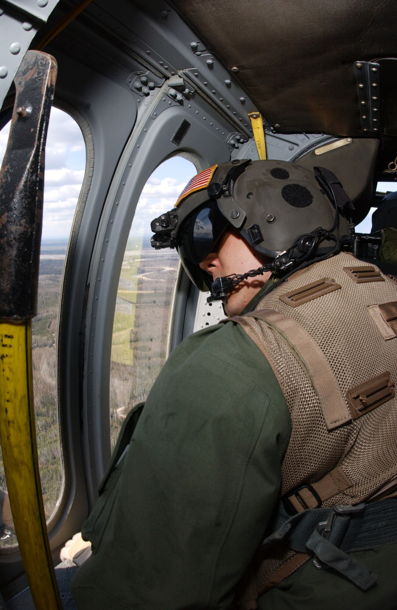 EIELSON AIR FORCE BASE, Alaska -- Staff Sgt. Ken Gillum, 210th Rescue Squadron Detachment 1 aerial gunner, scans the terrain below for suspicious activity over the Trans-Alaska Pipeline System on May 10 during Northern Edge. This exercise is Alaska's premier joint training exercise designed to practice operations, techniques and procedures, and enhance interoperability among the services ranging from Airman, Soldiers, Sailors, Marines, Coast Guardsmen and Civilian emergency response teams. (U.S. Air Force Photo by Airman 1st Class Jonathan Snyder) 