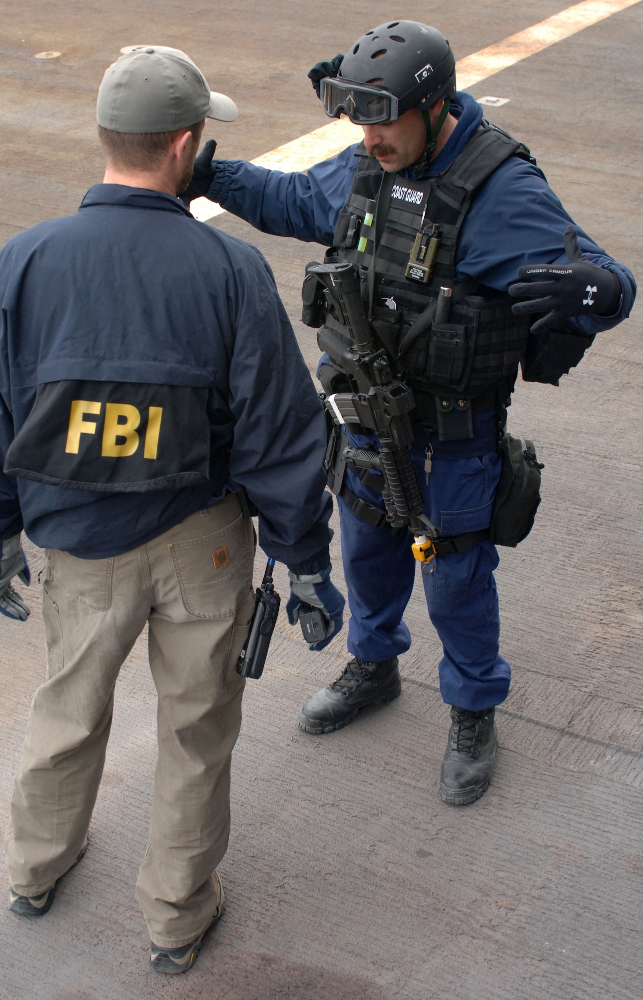SEWARD, Alaska (May 11, 2007) – A member of U.S. Coast Guard Maritime Safety & Security Team, Anchorage (MSST 91111) speaks with a FBI special agent after completing a search of USNS Henry J. Kaiser (T-AO 187) as part of Alaska Shield/Northern Edge 07 (AKS/NE 07). AKS/NE 07 is a State of Alaska/US NORTHCOM sponsored homeland defense/defense support of civil authorities exercise; part of the national-level Ardent Sentry/Northern Edge 07.  It’s an opportunity to practice responding to homeland defense/disaster events with the federal, state, local & private-sector team. U.S. Navy photo by Mass Communication Specialist 1st Class Daniel N. Woods