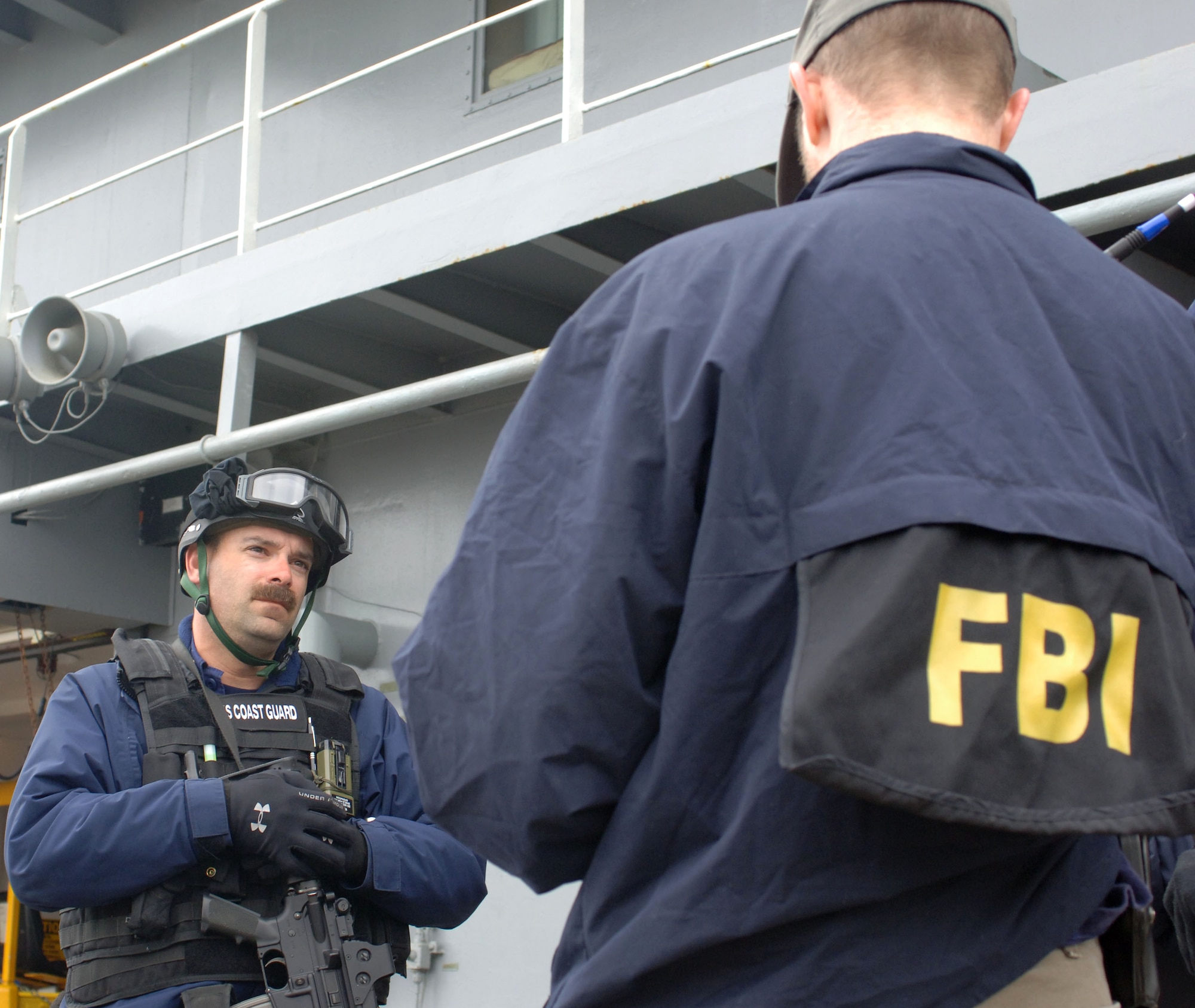 SEWARD, Alaska (May 11, 2007) – A member of U.S. Coast Guard Maritime Safety & Security Team, Anchorage (MSST 91111) speaks with a FBI special agent after completing a search of USNS Henry J. Kaiser (T-AO 187) as part of Alaska Shield/Northern Edge 07 (AKS/NE 07). AKS/NE 07 is a State of Alaska/US NORTHCOM sponsored homeland defense/defense support of civil authorities exercise; part of the national-level Ardent Sentry/Northern Edge 07.  It’s an opportunity to practice responding to homeland defense/disaster events with the federal, state, local & private-sector team. U.S. Navy photo by Mass Communication Specialist 1st Class Daniel N. Woods