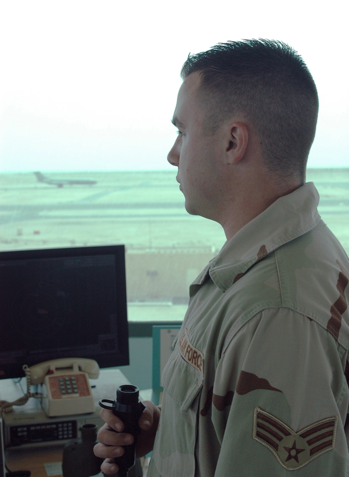 Senior Airman Dustin Storm watches as a British Royal Air Force VC-10 air tanker taxis after landing at his deployed location.  Airman Storm is an air traffic controller assigned to the 379th Expeditionary Operations Support Squadron.  (U.S. Air Force Photo/Senior Airman Erik Hofmeyer) 