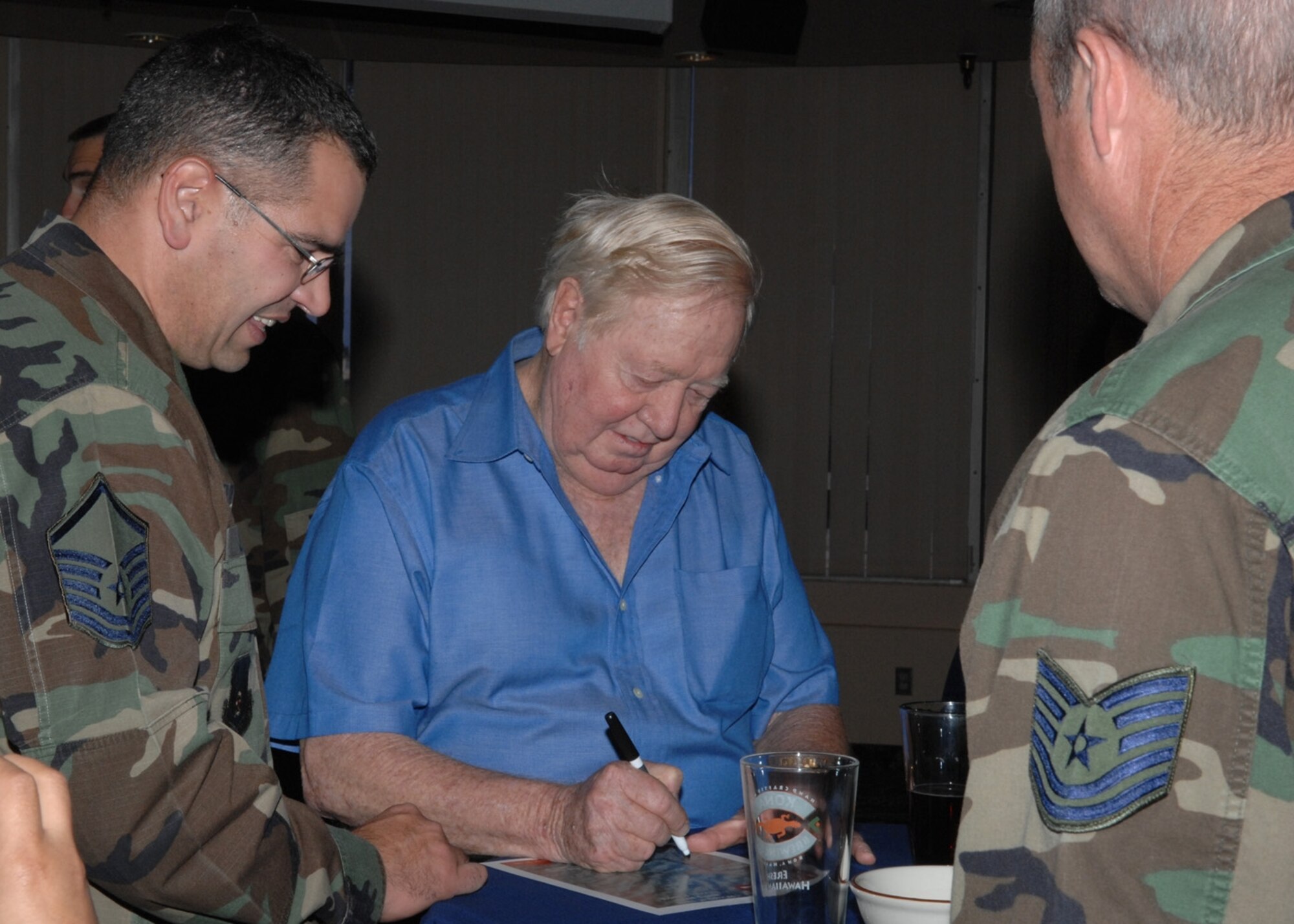 Retired Col. Joe Kittinger signs autographs and tells Airmen of his time in the Air Force. Colonel Kittinger was in projects such as Man High and Excelsior and holds the world record for completing a helium balloon jump from more than 100,000 feet. (U.S. Air Force photo by Airman 1st Class Rachel Kocin)