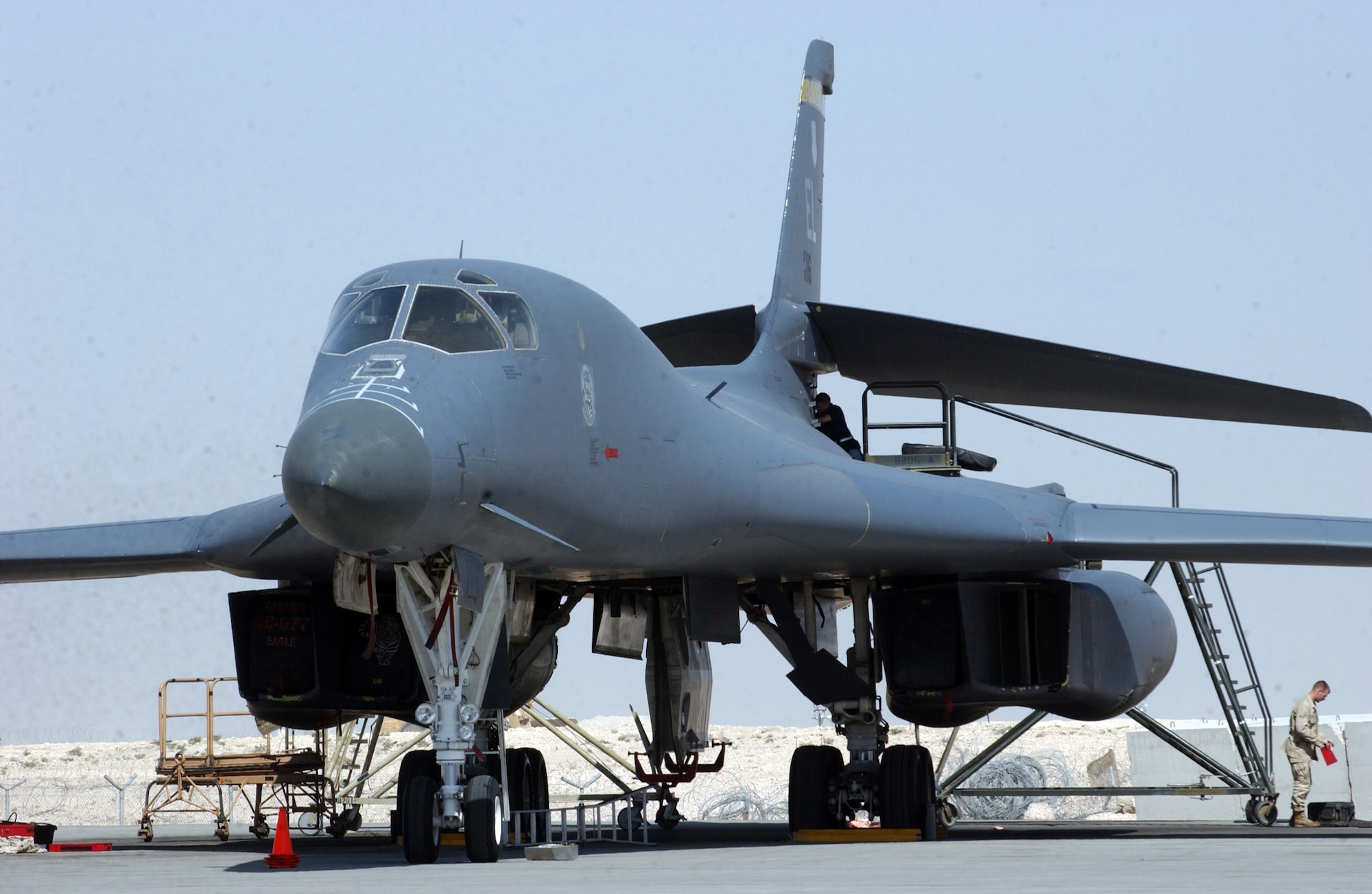 Maintainers service a B-1B Lancer prior to its next mission. B-1 bombers supported both Operation Enduring Freedom and Operation Iraqi Freedom May 13. The B-1 carries the largest payload of both guided and unguided weapons in the Air Force inventory.  (U.S. Air Force photo) 
