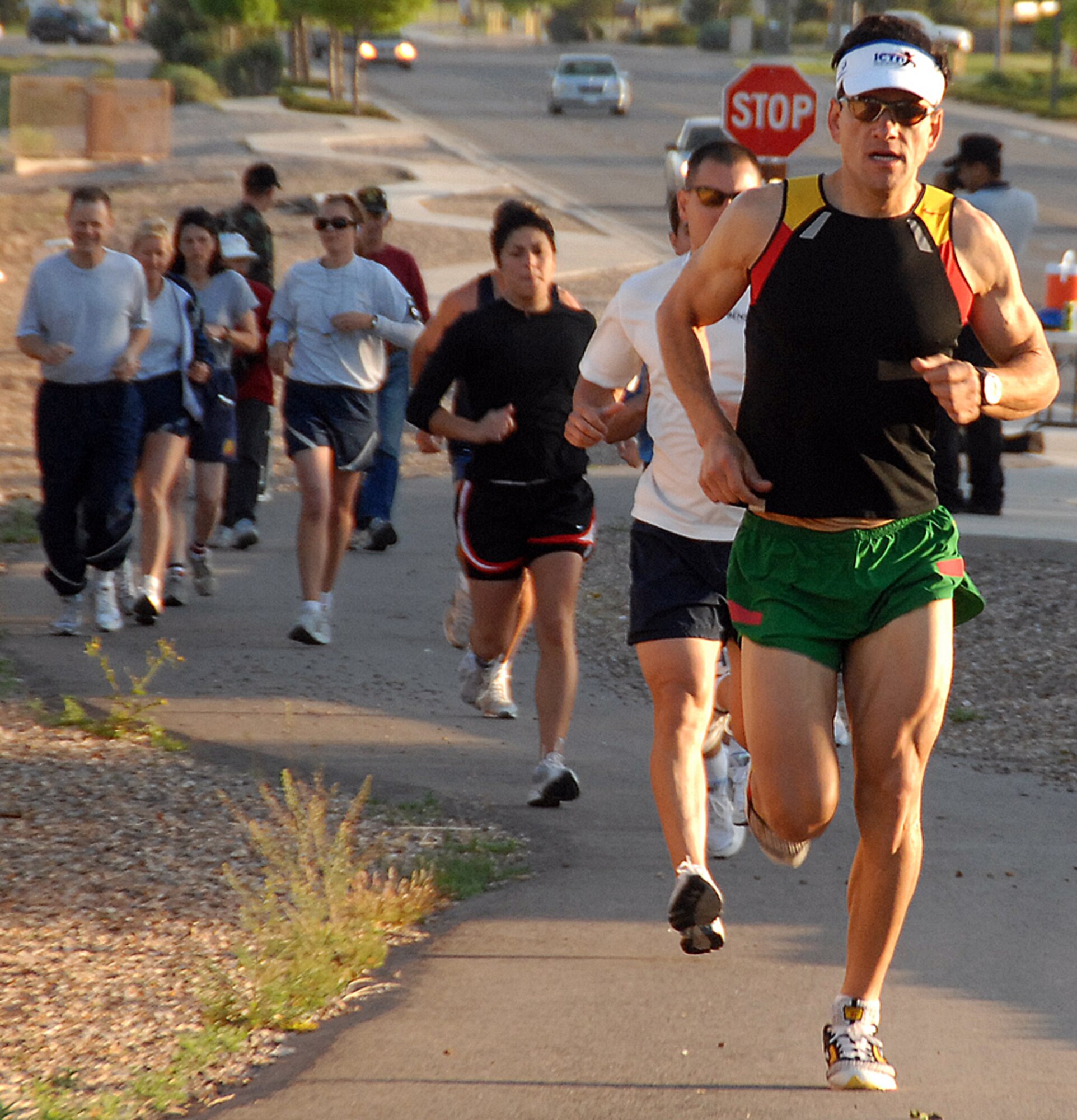 Army Maj. Hector Tovar from the Defense Threat Reduction Agency leads the way in the kickoff of May Fitness Month with a 5km Fitness Run early Tuesday morning. The East Fitness Center has a month packed with activities including 25 events ranging from Family Day to Water Polo. U.S. Air Force photo by Todd Berenger