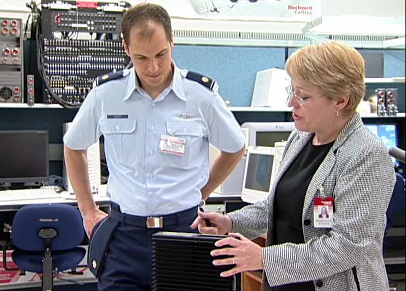 Maj. Daniel Cozzi talks with Rebecca Morrison about the Comprehensive Combat Flight Information System during a demonstration for the system in October 2006 at Rockwell's aviation laboratory in Cedar Rapids, Iowa. Ms. Morrison is a systems engineer for Rockwell Collins International, Inc. Major Cozzi is the project officer for the battlelab initiative Air Mobility Battlelab assigned to the Air Force Expeditionary Center at Fort Dix, N.J. (U.S. Air Force photo) 
