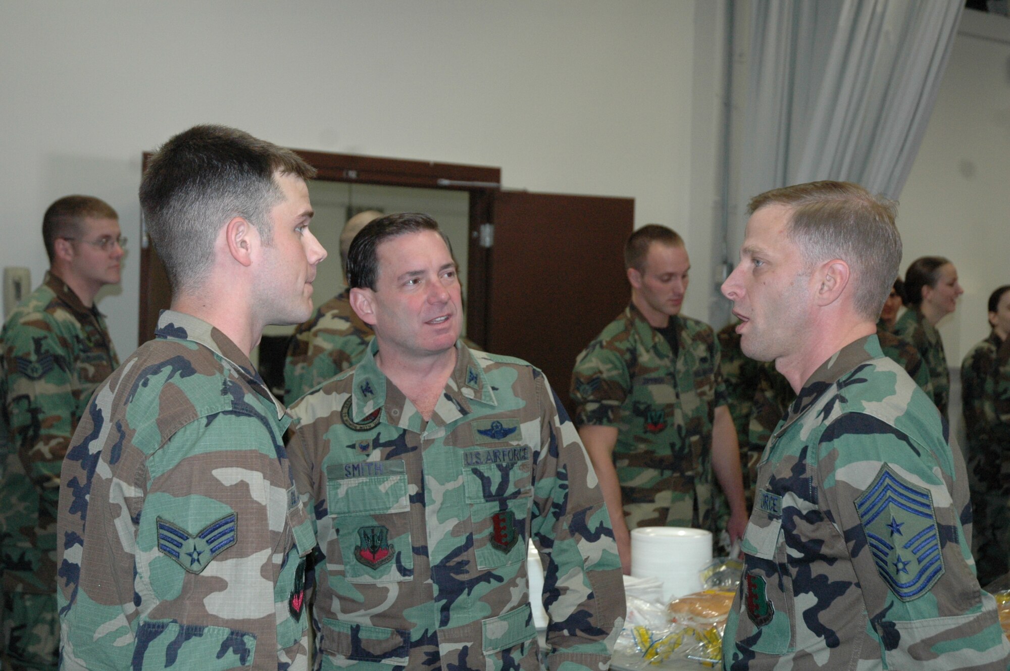 Col. Jeffry Smith, 28th Bomb Wing commander and Chief Master Sgt. John Gillette, 28th Bomb Wing command chief talk with an airman during a junior enlisted farewell luncheon held here for Col. Smith May 11.  The Ellsworth Group 5/6 sponsored the event in honor of Col. Smith's past 2 years as the bomb wing commander.  Col. Smith will turn over the wing to Col. Scott Vander Hamm during a change of command ceremony on June 1. (U.S. Air Force photo/Tech. Sgt. Todd Wivell)