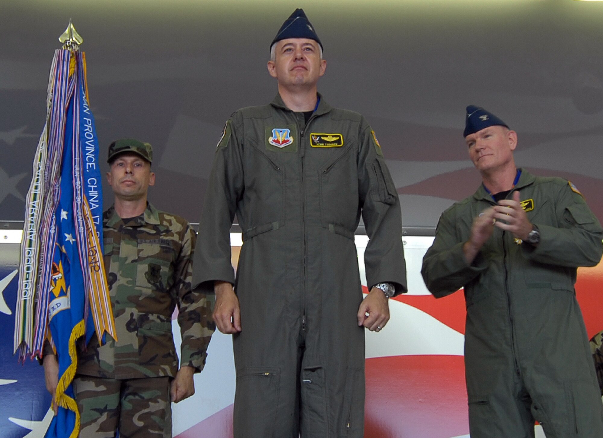 Col. Kenn Todorov addresses his first wing formation moments after assuming command of the 23rd Wing May 11 as Command Chief Master Sgt. Michael Mazzi and the outgoing 23rd Wing commander, Col. Joe Callahan watch.  