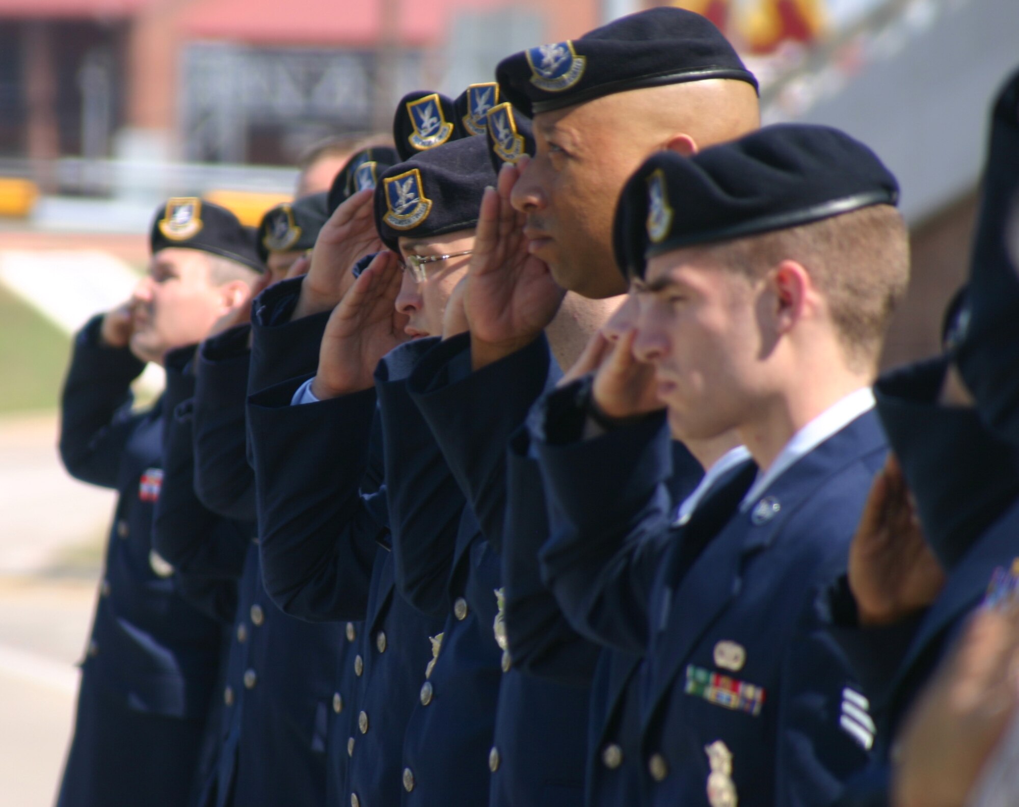 Members of the 82nd Security Forces Squadron render salutes to the nation's flag May 14 during a ceremony to honor fallen law enforcement officers. More than 145 officers were killed in the line of duty in 2006. (U.S. Air Force photo/John Ingle)