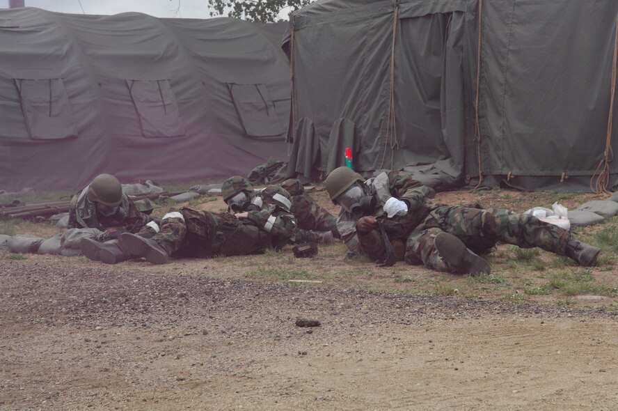 MINOT AIR FORCE BASE, N.D. – Airmen from the 5th Medical Group take cover during a simulated chemical attack as part of an annual medical-readiness training exercise here May 8 and 10. Airmen practiced providing patient treatment, responding to simulated chemical threats and acknowledging public-health issues. Approximately 150 Airmen from the 5th MDG participated in the exercise. (U.S. Air Force photo by Airman 1st Class Joe Rivera)