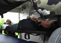 MINOT AIR FORCE BASE, N.D. – Airmen from the 5th Medical Group place a patient into an ambulance during the group’s annual medical-readiness training exercise here May 8 and 10. Airmen practiced providing patient treatment, responding to simulated chemical threats and acknowledging public-health issues. Approximately 150 Airmen from the 5th MDG participated in the exercise, along with volunteers from other squadrons who served as patients. (U.S. Air Force photo by Airman 1st Class Joe Rivera)