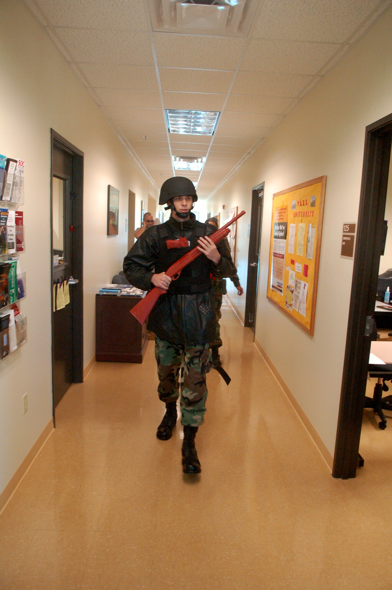 LAUGHLIN AIR FORCE BASE, Texas -- A gunman, played by 2nd Lt. Steven Benson, 47th Security Forces Squadron, stalks the halls of the Laughlin Education Center searching for potential victims during an exercise May 10. (U.S. Air Force photo by Staff Sgt. Austin M. May)