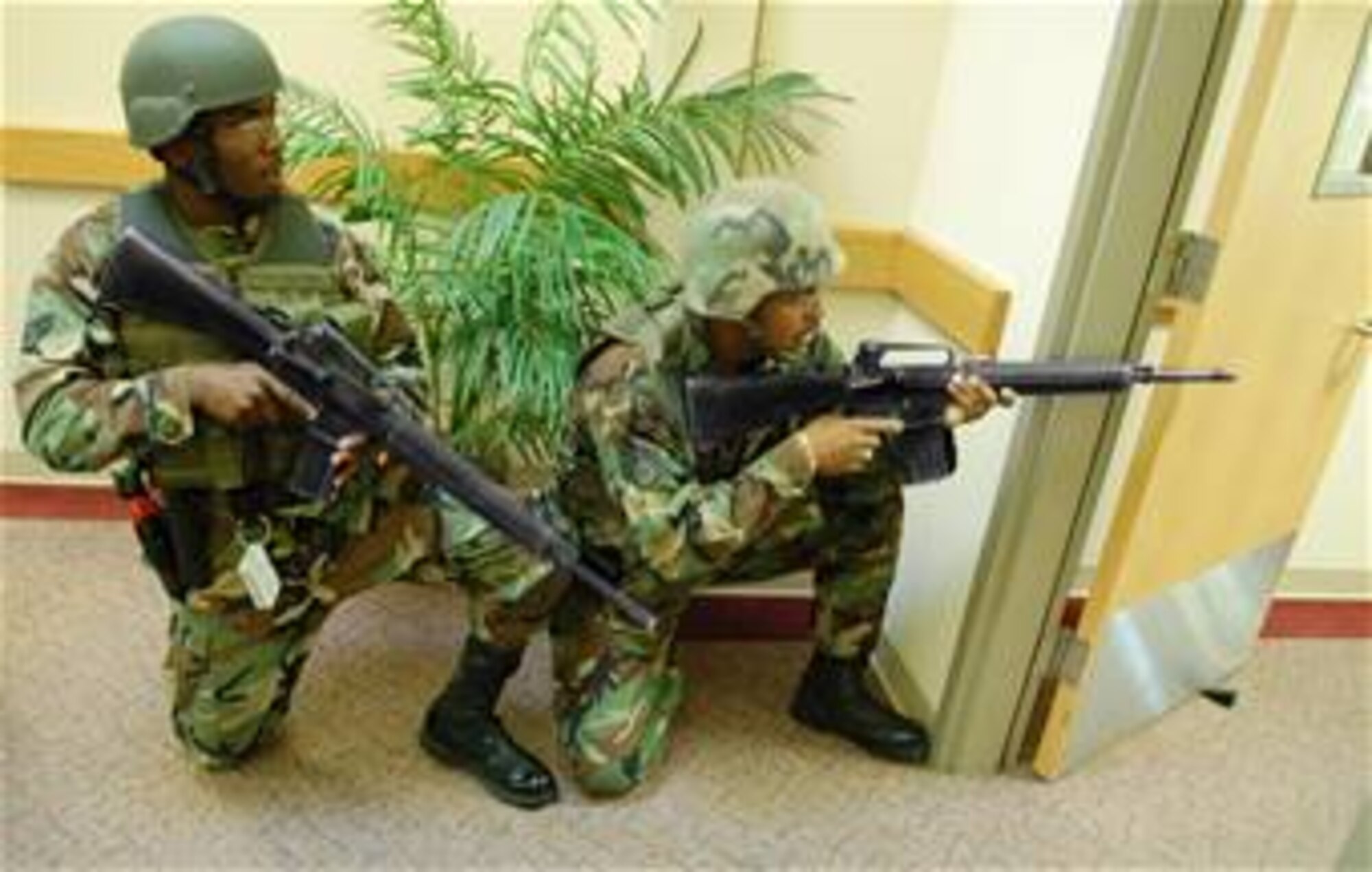 LAUGHLIN AIR FORCE BASE, Texas -- Two members of the 47th Security Forces Squadron immerse themselves in a tense showdown with a lone gunman in the 47th Force Support Squadron during an exercise May 10.  (U.S. Air Force photo illustration by Staff Sgt. Austin M. May)