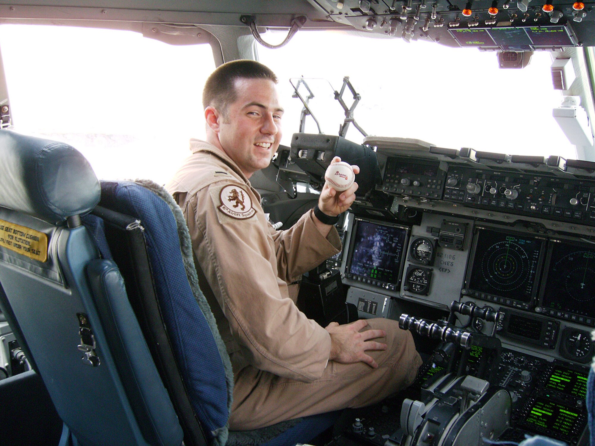 First Lt. Ryan Brewer, an 816th Expeditionary Airlift Squadron pilot, displays one of the Atlanta Braves baseballs being passed around deployed locations. The Georgian native recorded a shout out for the Atlanta home game to be played Sept. 18, on the Air Force's 60th Anniversary. Atlanta will be hosting several events leading up to Air Force Week, Heritage to Horizons, celebration. to be held Oct. 8 to 14 in Atlanta.  (U.S. Air Force photo/Capt. Wes Ticer) 

 
