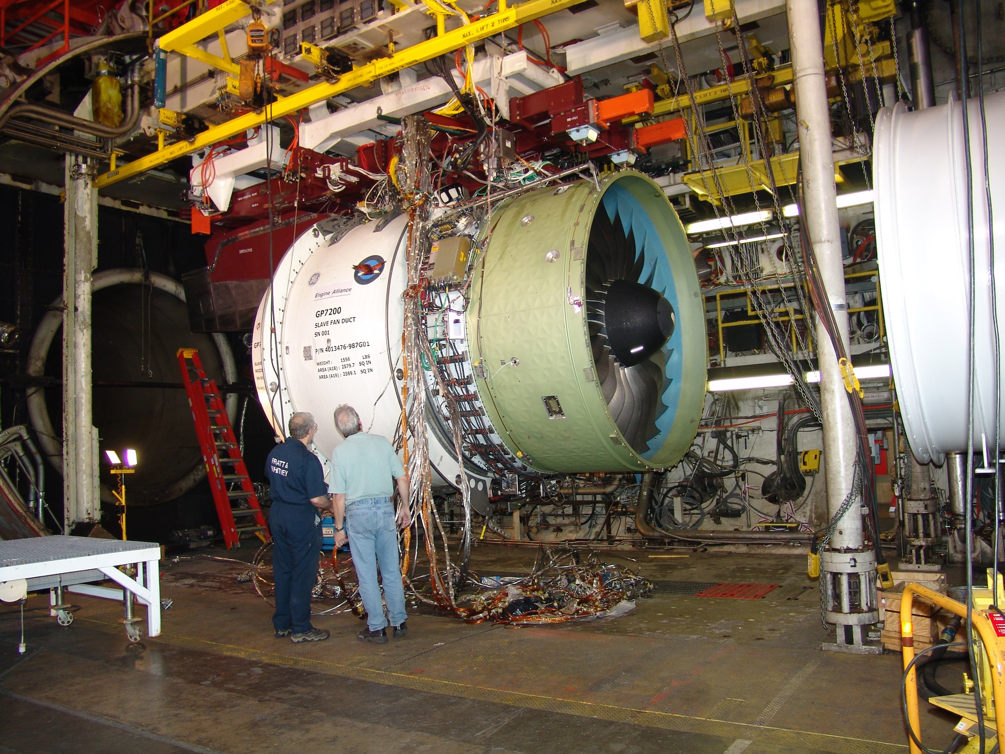 A Pratt & Whitney engine technical specialist and an AEDC technician inspect a GP7200 engine, one of the power plants for the Airbus Industries A380, in April 2004 prior to testing in AEDC’s Aeropropulsion Systems Test Facility Test Cell. The GP7200 is manufactured under the GE-Pratt & Whitney Engine Alliance.