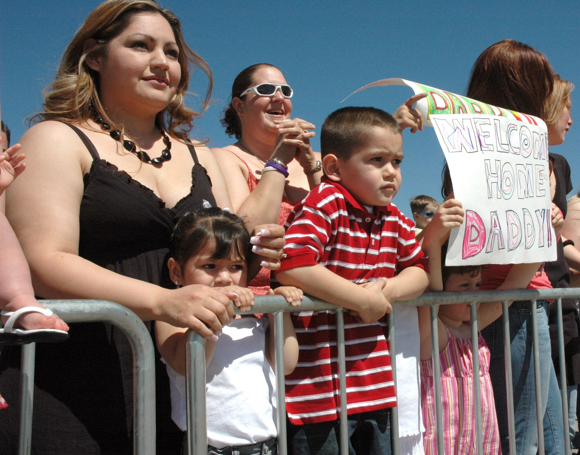Families members await the return of 35 Airmen May 8 from the 366th Civil Engineer Squadron at Mountain Home Air Force Base, Idaho. The base welcomed home the squadron members who served at forward operating locations in Iraq and Afghanistan over the past seven months to build new work centers and living quarters to accommodate additional forces arriving in the region as part of the military's ongoing troop surge. (U.S. Air Force photo/Master Sgt. Brian S. Orban)