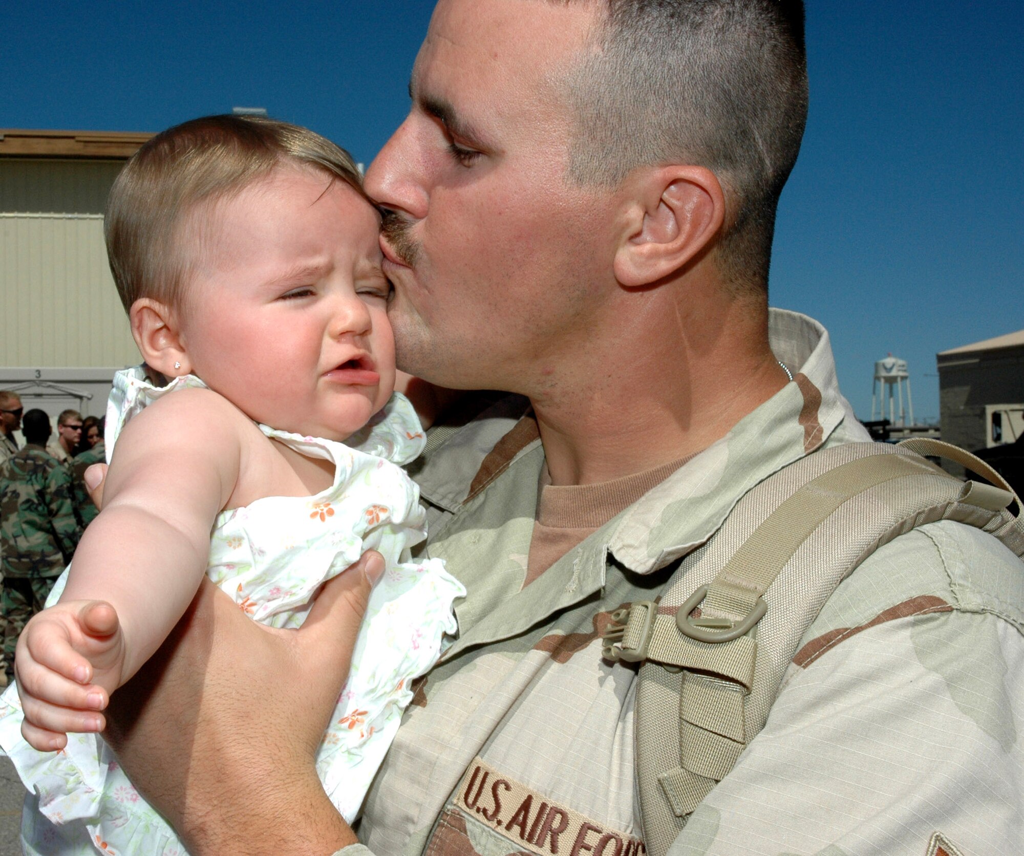 Staff Sgt. Brent Rice reunites with his baby daughter, Kayden, after the sergeant and other members of the 366th Civil Engineer Squadron returned May 8 to Mountain Home Air Force Base, Idaho. The returning 35 deployed members served the past seven months at forward operating locations in Iraq and Afghanistan building new work centers and living quarters to accommodate additional forces arriving in the region. (U.S. Air Force photo/Master Sgt. Brian S. Orban)