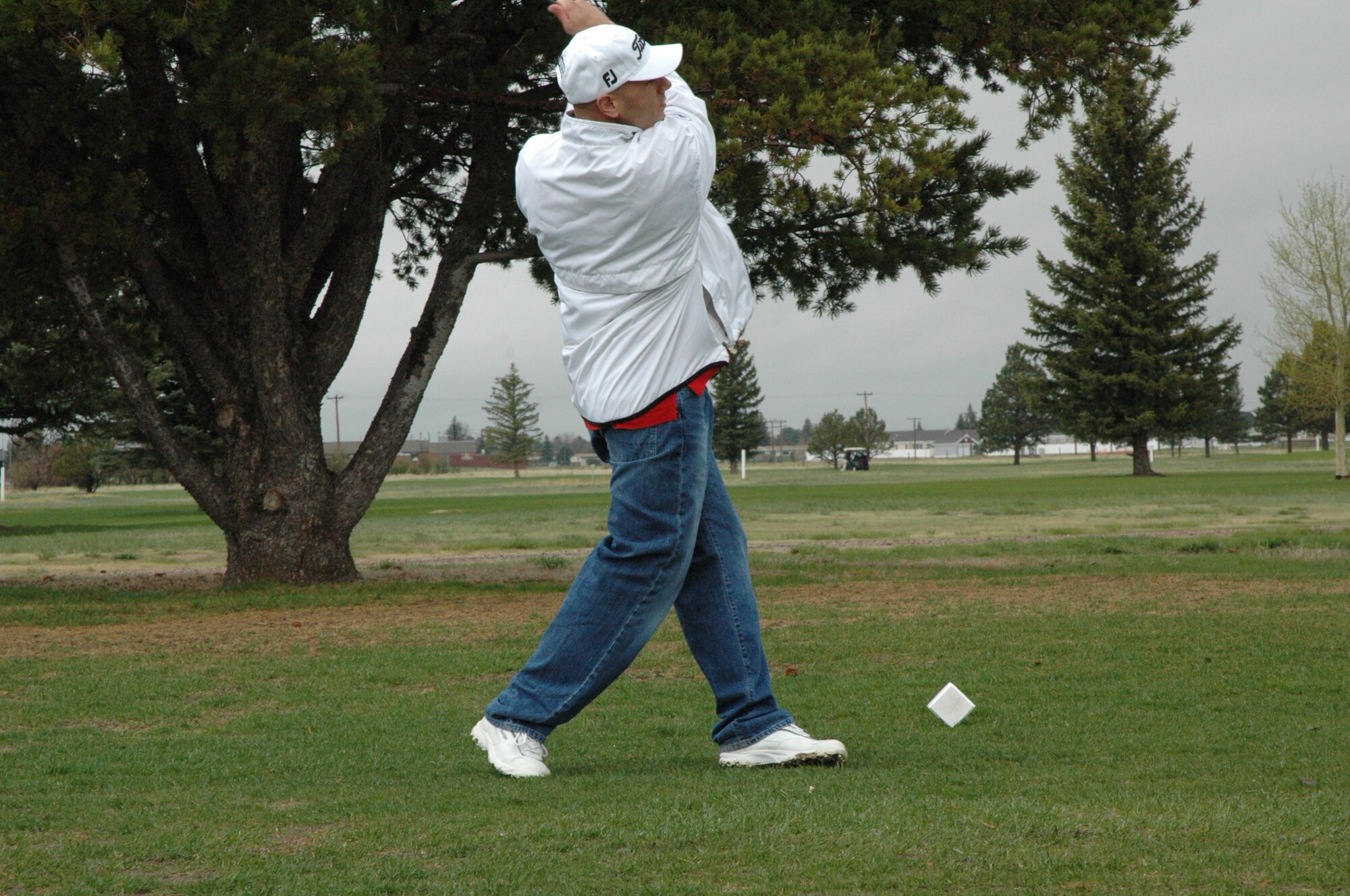 Tech. Sgt. David Bedner, 90th Operations Support Squadron, hits a golf ball during the Warren Spouses Club Golf Tournament Friday. Although the day was a cold and cloudy one, the tourney had a large number of participants (Photo by Airman Alex Martinez).