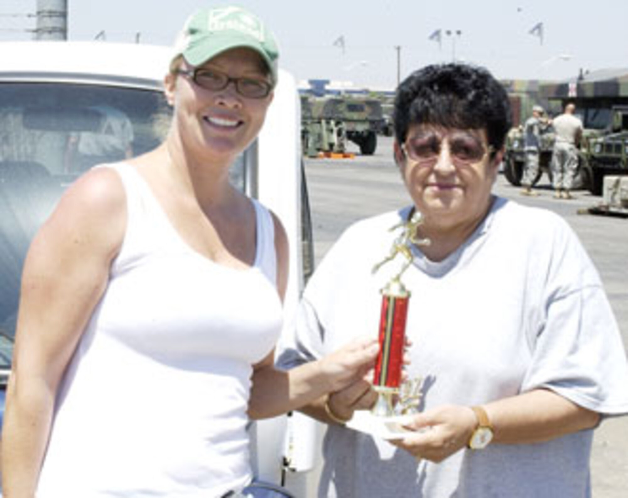 Brenda Hendricksen receives her first place trophy from Sports and Fitness director
Linda Butler for running a 24:25 in the five kilometer race at March Air Reserve Base. (U.S. Air Force photos by Staff Sgt. Amy Abbott)