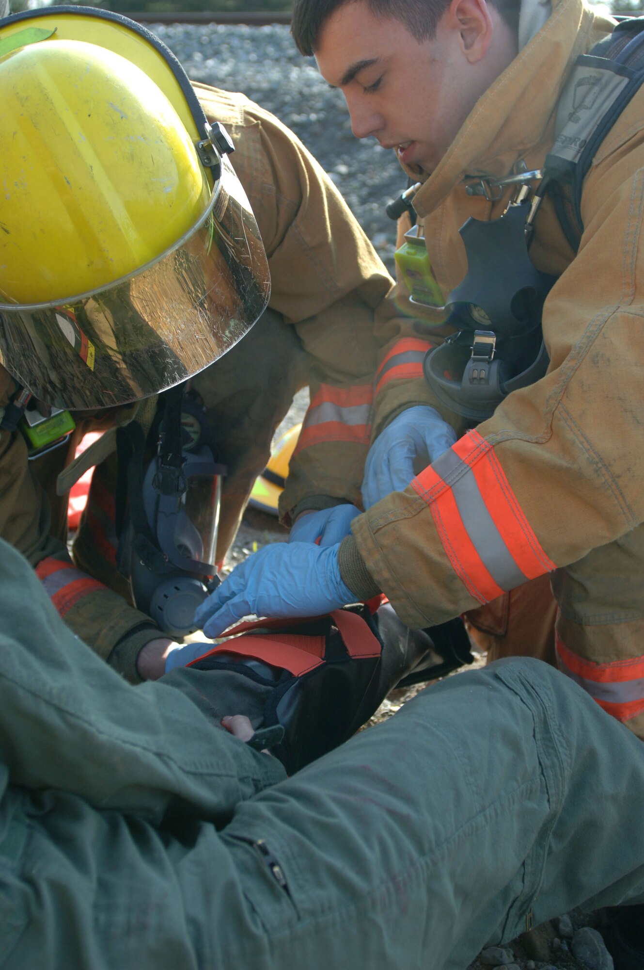 ELMENDORF AIR FORCE BASE, Alaska (May 15, 2007) – Elmendorf Air Force Base firefighters place a splint on a simulated accident victim to immobilize her broken leg in preparation for movement to higher medical care as part of a scenario for Alaska Shield/Northern Edge 07. AKS/NE 07 is a State of Alaska/US NORTHCOM sponsored homeland defense/defense support of civil authorities exercise; part of the national-level Ardent Sentry/Northern Edge 07.  The exercise is an opportunity to practice responding to homeland defense/disaster events with the federal, state, local & private-sector team. U.S. Navy photo by Mass Communication Specialist 1st Class Daniel N. Woods