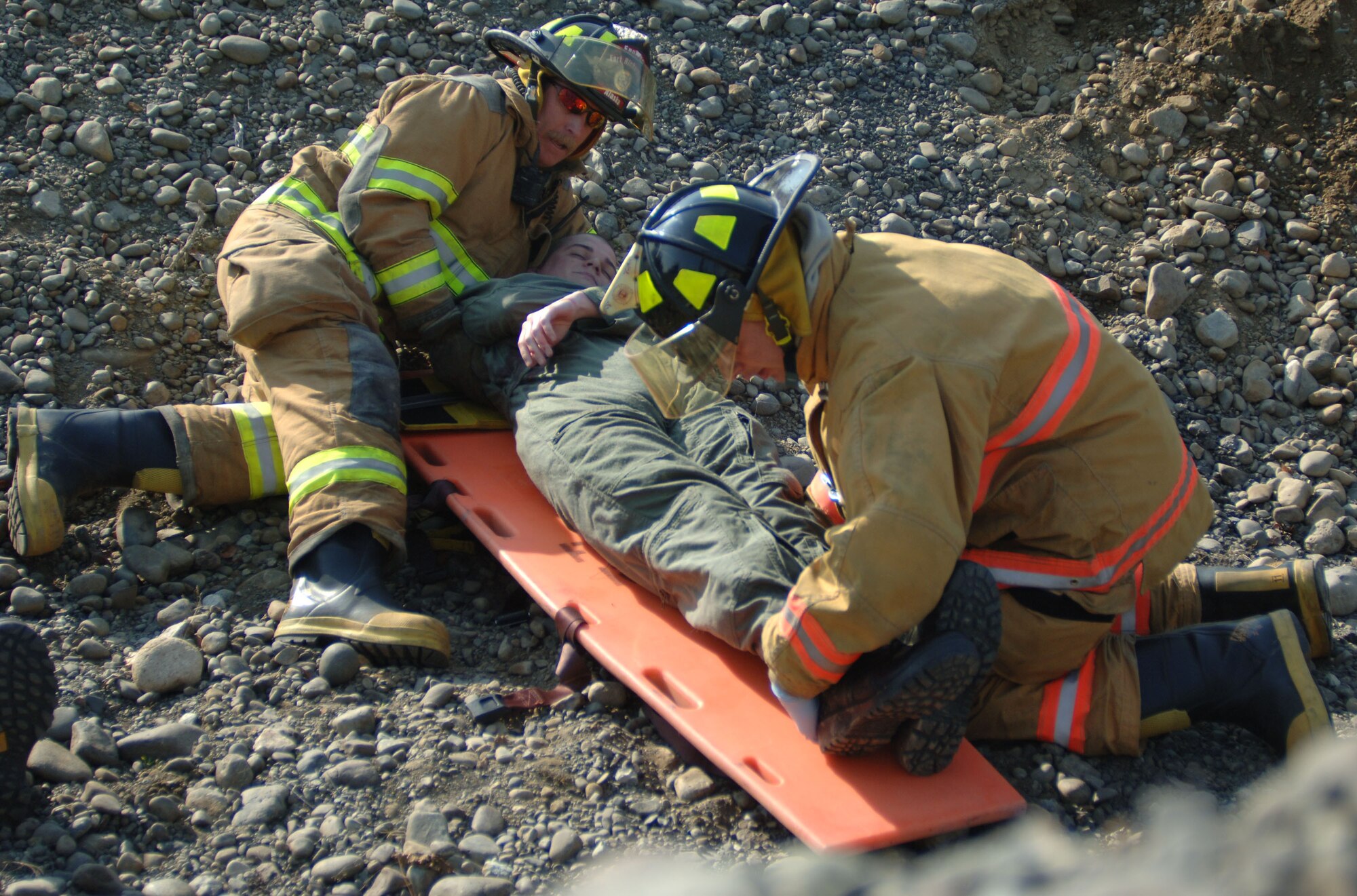 ELMENDORF AIR FORCE BASE, Alaska (May 15, 2007) – Elmendorf Air Force Base firefighters place a simulated accident victim on a backboard in preparation for movement to higher medical care as part of a scenario for Alaska Shield/Northern Edge 07. AKS/NE 07 is a State of Alaska/US NORTHCOM sponsored homeland defense/defense support of civil authorities exercise; part of the national-level Ardent Sentry/Northern Edge 07.  The exercise is an opportunity to practice responding to homeland defense/disaster events with the federal, state, local & private-sector team. U.S. Navy photo by Mass Communication Specialist 1st Class Daniel N. Woods