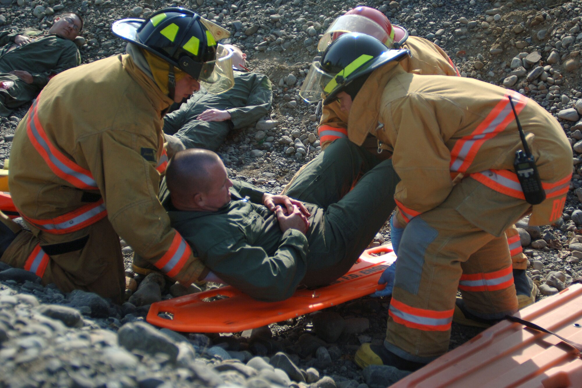 ELMENDORF AIR FORCE BASE, Alaska (May 15, 2007) – Elmendorf Air Force Base firefighters place a simulated accident victim on a backboard in preparation for movement to higher medical care as part of a scenario for Alaska Shield/Northern Edge 07. AKS/NE 07 is a State of Alaska/US NORTHCOM sponsored homeland defense/defense support of civil authorities exercise; part of the national-level Ardent Sentry/Northern Edge 07.  The exercise is an opportunity to practice responding to homeland defense/disaster events with the federal, state, local & private-sector team. U.S. Navy photo by Mass Communication Specialist 1st Class Daniel N. Woods