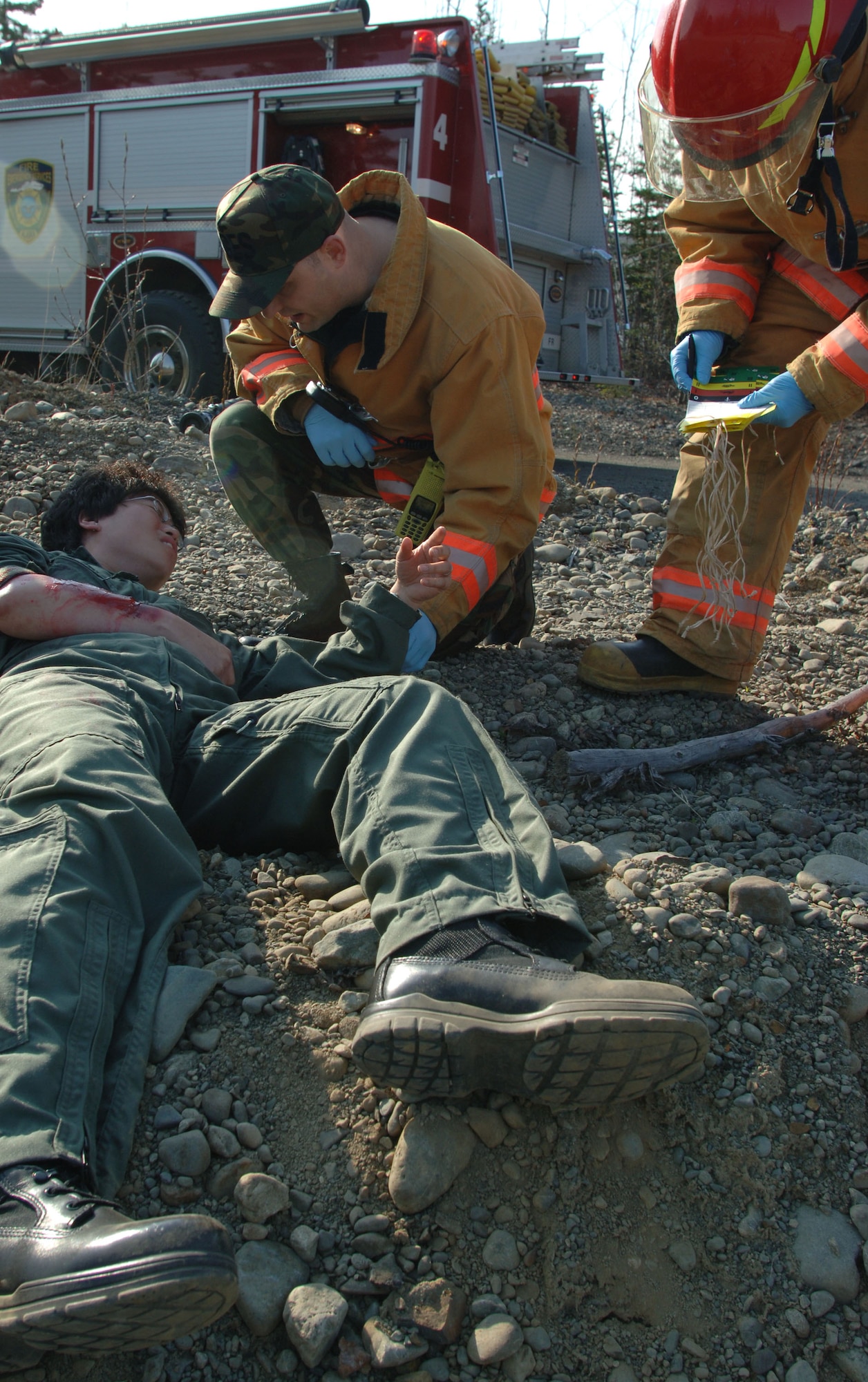 ELMENDORF AIR FORCE BASE, Alaska (May 15, 2007) – Elmendorf Air Force Base firefighters triage a simulated accident victim as part of a scenario for Alaska Shield/Northern Edge 07. AKS/NE 07 is a State of Alaska/US NORTHCOM sponsored homeland defense/defense support of civil authorities exercise; part of the national-level Ardent Sentry/Northern Edge 07.  The exercise is an opportunity to practice responding to homeland defense/disaster events with the federal, state, local & private-sector team. U.S. Navy photo by Mass Communication Specialist 1st Class Daniel N. Woods