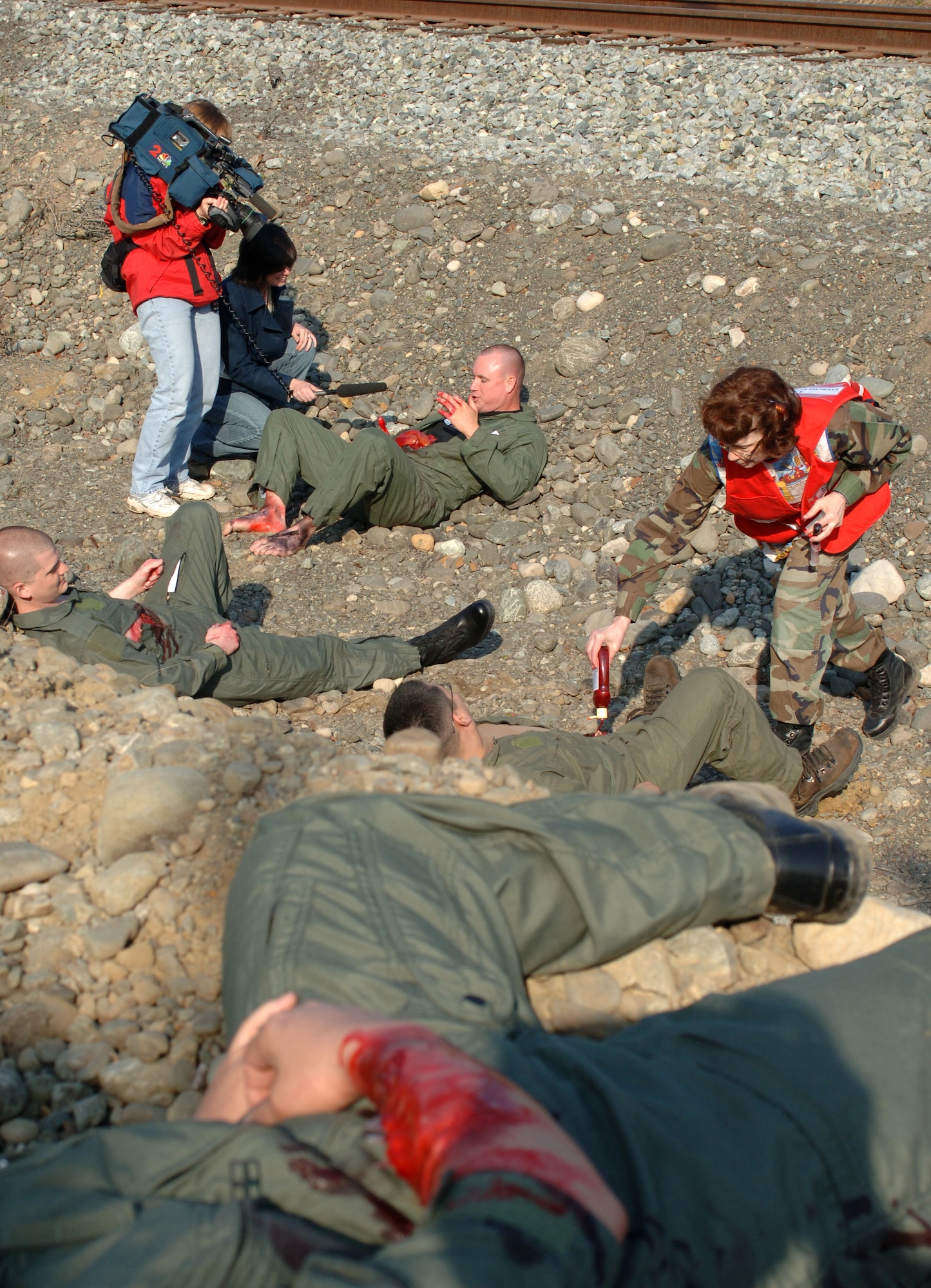 ELMENDORF AIR FORCE BASE, Alaska (May 15, 2007) – Local media from Anchorage, Alaska conducts an interview with a simulated accident victim as fake blood is applied to other simulated victims as part of a scenario for Alaska Shield/Northern Edge 07. AKS/NE 07 is a State of Alaska/US NORTHCOM sponsored homeland defense/defense support of civil authorities exercise; part of the national-level Ardent Sentry/Northern Edge 07.  The exercise is an opportunity to practice responding to homeland defense/disaster events with the federal, state, local & private-sector team. U.S. Navy photo by Mass Communication Specialist 1st Class Daniel N. Woods