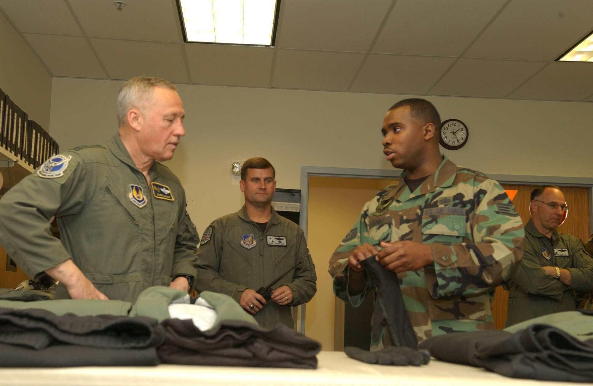 EIELSON AIR FORCE BASE, Alaska --Staff Sgt. Burnell Domino, 355th Fighter Squadron, shows General Bruce Carlson, Air Force Mobility Command commander, layers of a flight suit on May 14. Sergeant Domino shows how the layers of  the new flight suit makes it easier to move around the cockpit and still stay warm. (U.S. Air Force photo by Airman 1st Class Christopher Griffin)