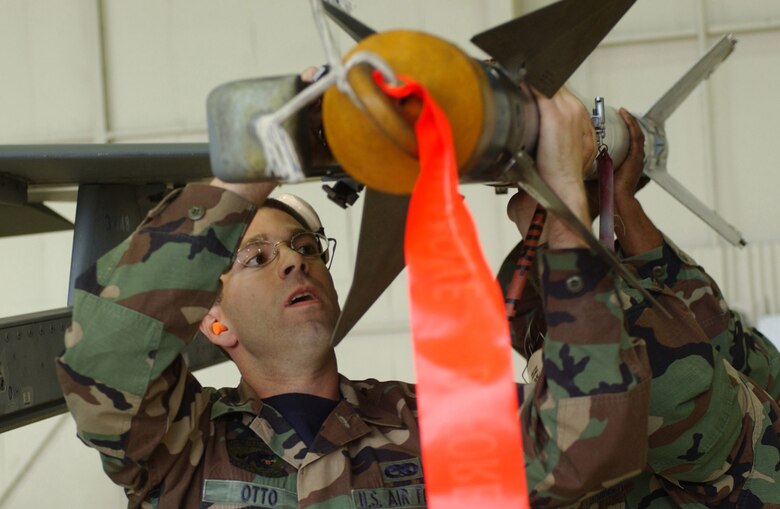 KUNSAN AIR BASE, Republic of Korea  May 12, 2007 -- Senior Airman Garrett Otto, 8th Aircraft Maintenance Squadron weapons loader, slides an AIM-9 Sidewinder missile onto an 8th Fighter Wing "Wolf Pack" F-16 Fighting Falcon launcher rail during the semi-annual 7th Air Force peninsula-wide weapons loading competition. This competition is held between Osan and Kunsan twice a year, once at each base. (U.S. Air Force photo/Senior Airman Darnell Cannady)                                                              