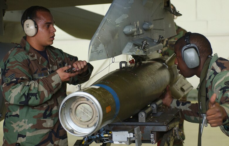 KUNSAN AIR BASE, Republic of Korea  May 12, 2007 -- Sweat pours down the side of Senior Airman Daniel Diaz's face (left) as he and Staff Sgt. Eric Harris, both assigned to the 8th Aircraft Maintenance Squadron, load a Guided Bomb Unit-10 laser-guided munition on the wing of an 8th Fighter Wing "Wolf Pack" F-16 Fighting Falcon during the semi-annual 7th Air Force peninsula-wide weapons loading competition. This competition is held between Osan Air Base and Kunsan twice a year, once at each base. (U.S. Air Force photo/Senior Airman Darnell Cannady)   