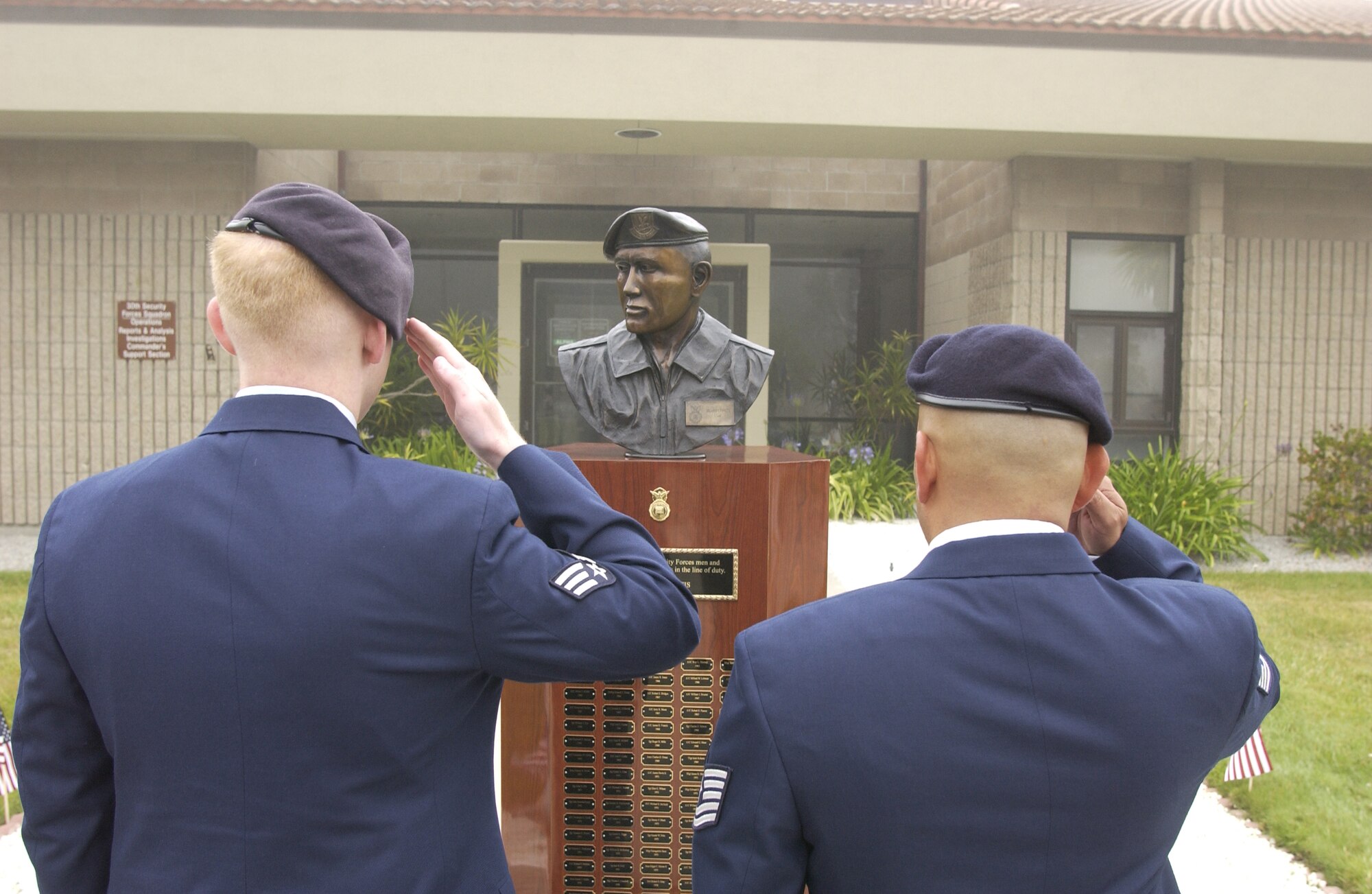 Senior Airman Donald Mace (left) and Tech. Sgt. Baltazar Ruiz (right) present arms to honor Cpl. David Williams, and Airman 1st Class Leebernard Chavis during a memorial ceremony held by the 30th Security Forces Squadron at Vandenberg on May 14. The security forces memorial reflects names of fallen Airmen in the security forces career field who were killed in the line of duty. (U.S. Air Force photo by Airman 1st Class Adam Guy)