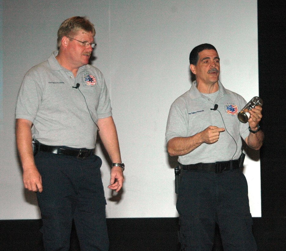 Florida firefighters Ronny Garcia (pictured right) and Kevin Reed give a SAFE brief to Ellsworth Airmen April 27 at the base theater.  SAFE features members of the medical and law enforcement  community who share their no-hold barred and grittily honest experiences with audiences around the world. (U.S. Air Force photo/Tech. Sgt. Todd Wivell)