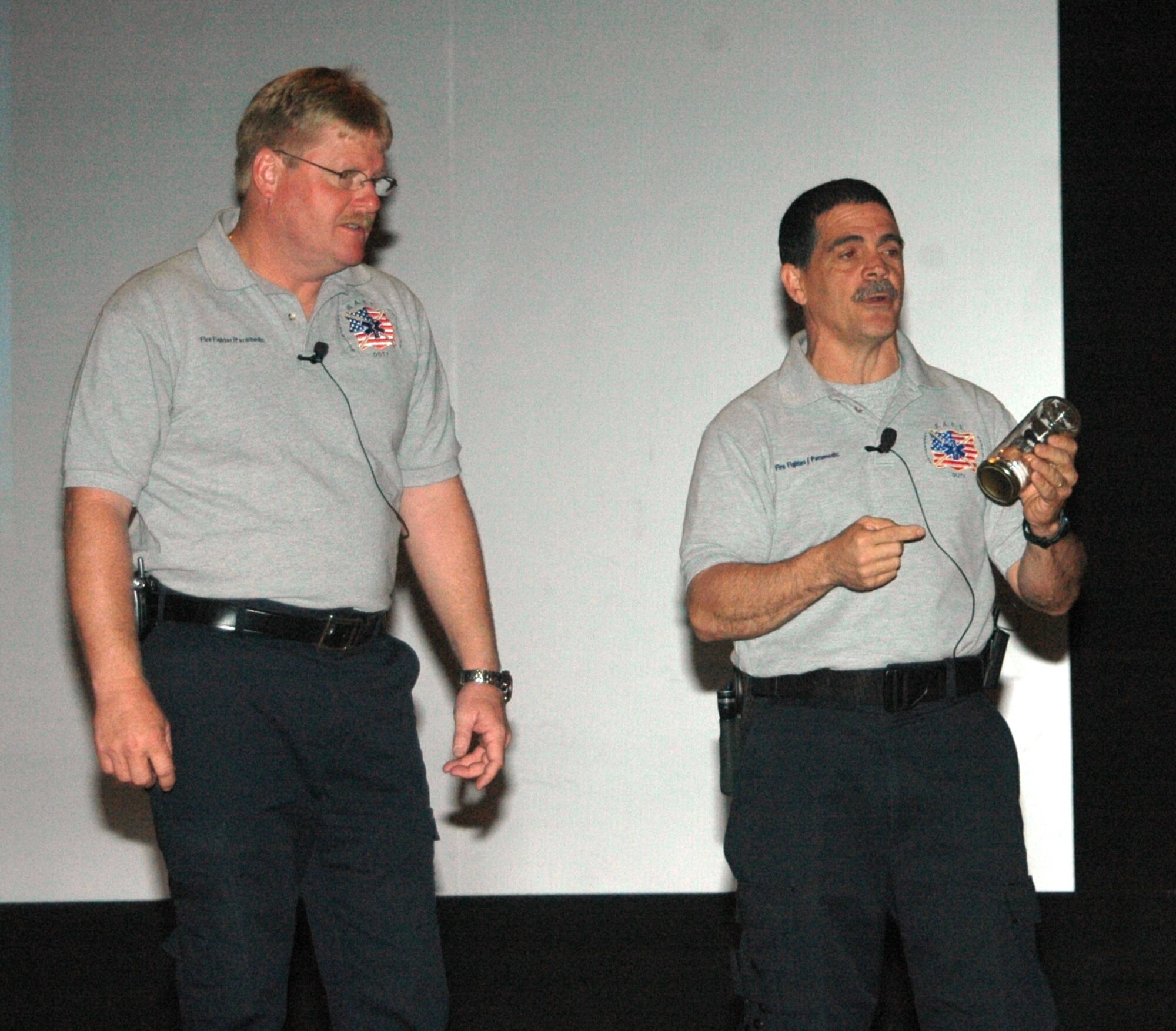 Florida firefighters Ronny Garcia (pictured right) and Kevin Reed give a SAFE brief to Ellsworth Airmen April 27 at the base theater.  SAFE features members of the medical and law enforcement  community who share their no-hold barred and grittily honest experiences with audiences around the world. (U.S. Air Force photo/Tech. Sgt. Todd Wivell)