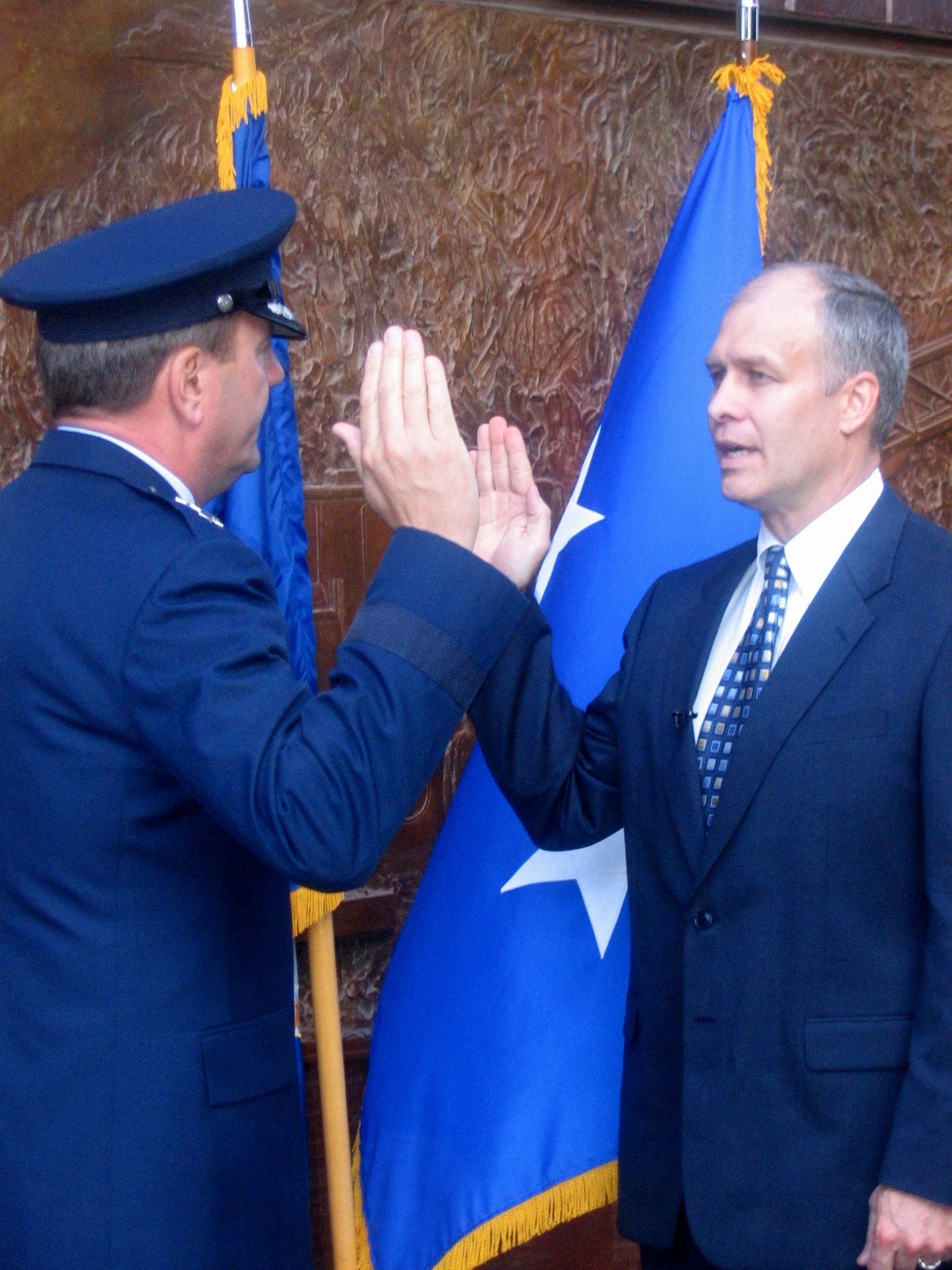 Dr. Alan Flower recites the oath of office, officiated by Maj. Gen. Rick Rosborg, in a ceremony at the "Ten House" fire station May 10 in New York City. Maj. (Dr.) Flower, who has been a family practice physician in New York for the past 14 years, will be assigned to the 335th Fighter Squadron at Seymour-Johnson Air Force Base, N.C., following completion of commissioned officer training this summer. General Rosborg and Major Flower grew up together in Bayville, N.Y. (U.S. Air Force photo/Staff Sgt. Monique Randolph) 
