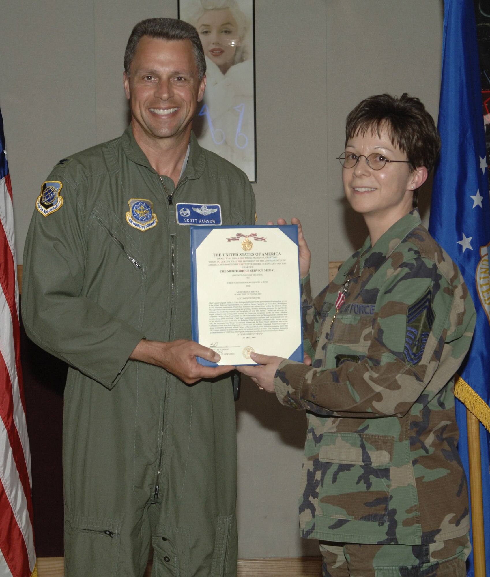 Col. Scott Hanson, 92nd Air Refueling Wing commander, presents Chief Master Sergeant Judith Ruiz with her certificate after she received the Meritorious Service Medal Seventh Oak Leaf Cluster. Chief Ruiz received the medal for her service from May 19, 2005 to June 25, 2007. (U.S. Air Force photo/ Senior Airman Chad Watkins)